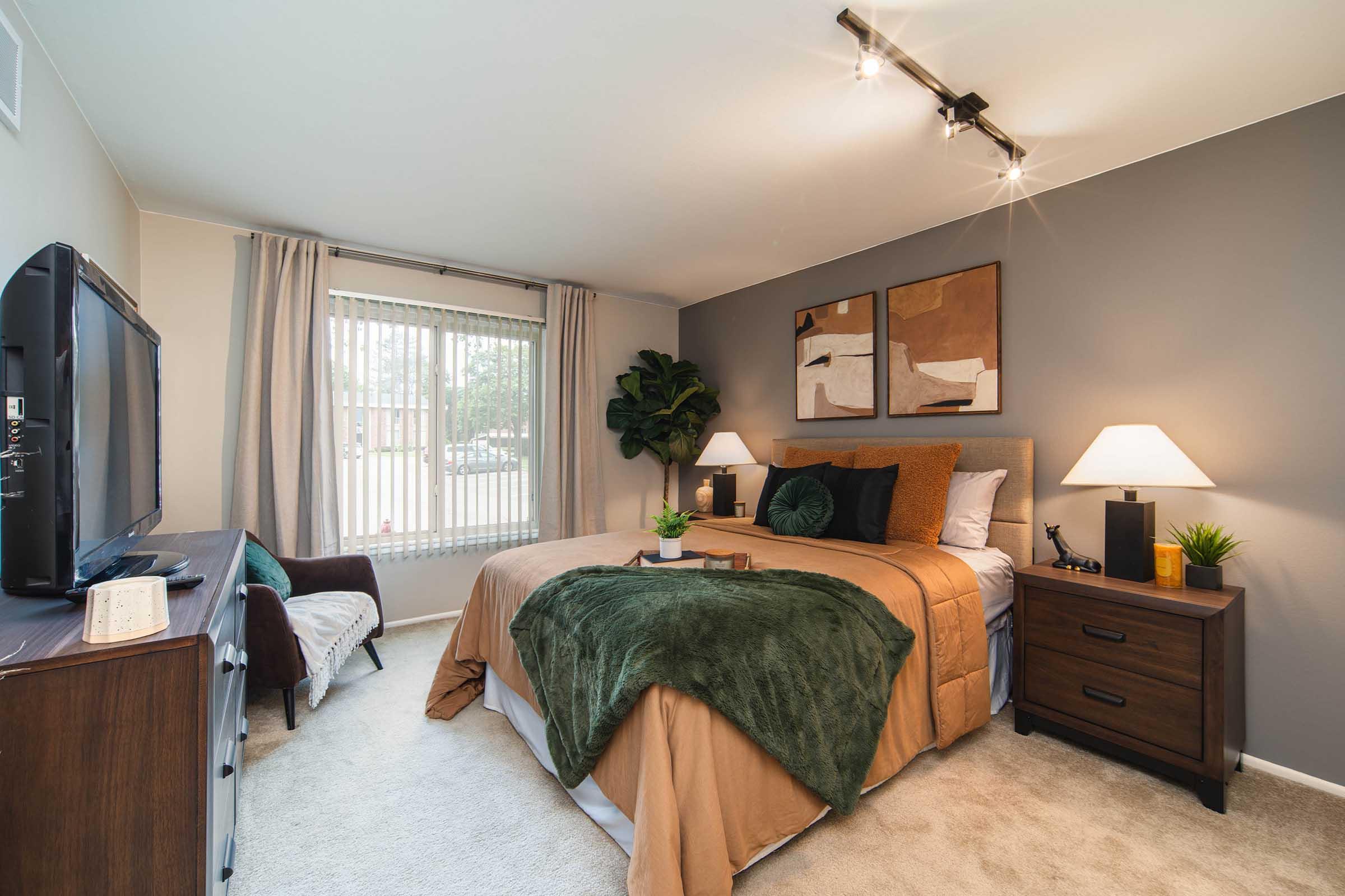 a living room filled with furniture and a bed in a bedroom