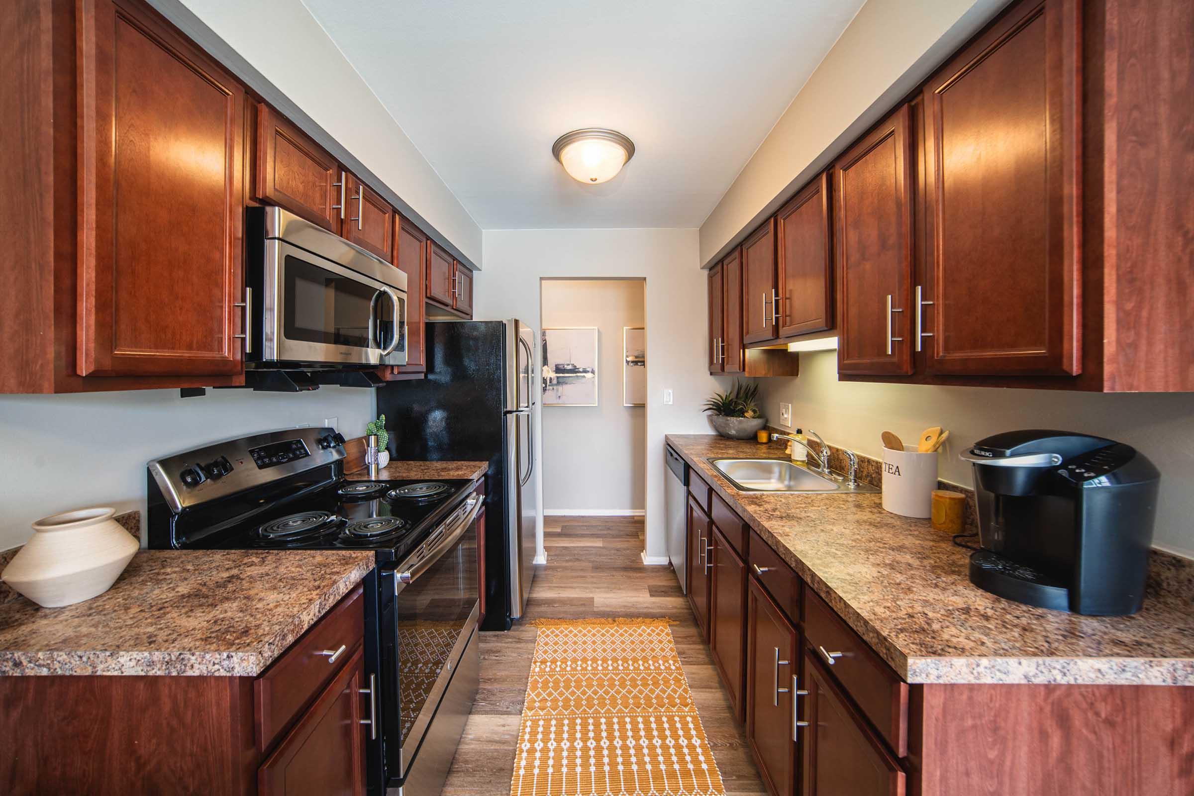 a modern kitchen with stainless steel appliances and wooden cabinets