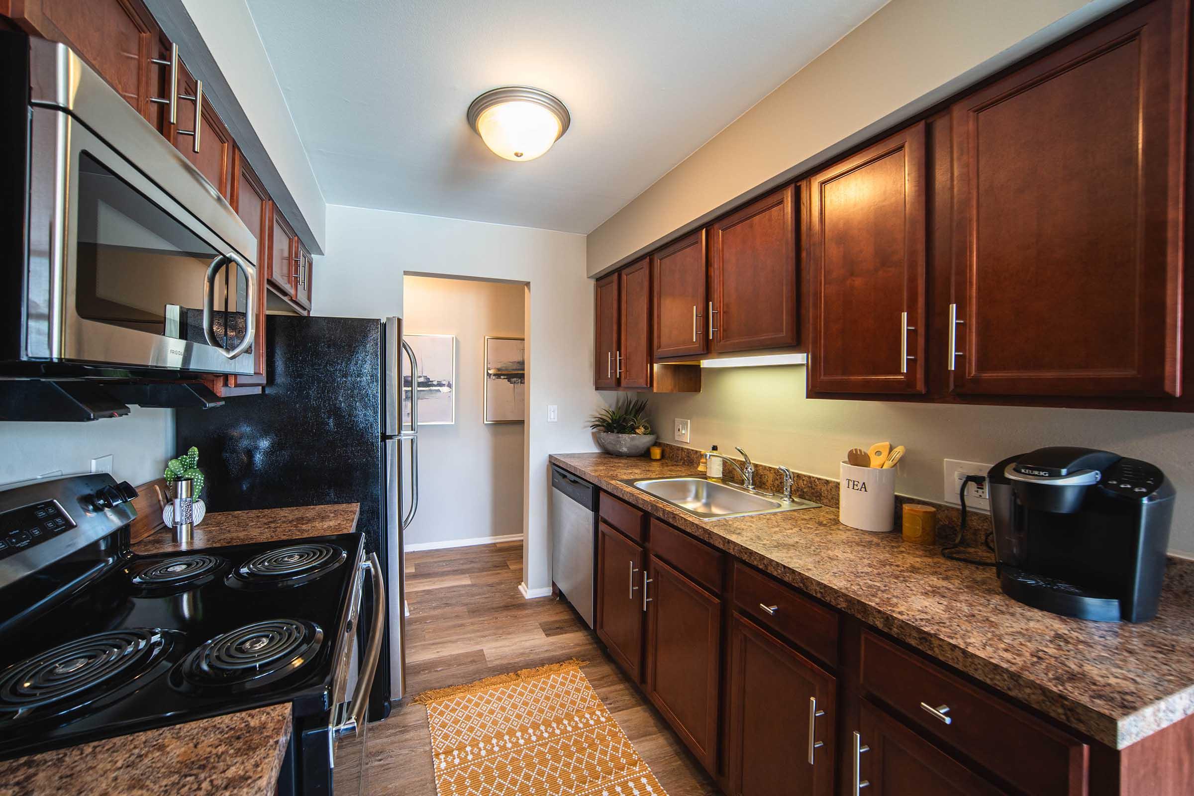 a modern kitchen with stainless steel appliances and wooden cabinets