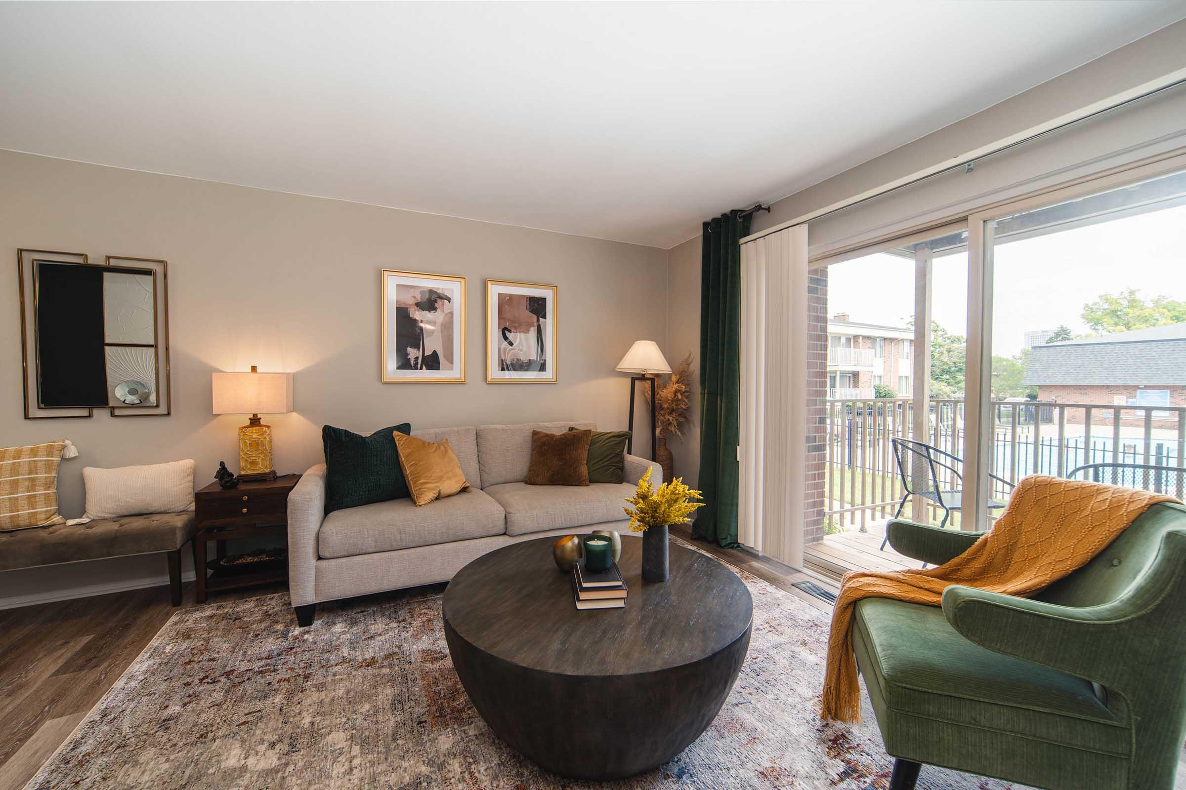 a living room filled with furniture and a large window