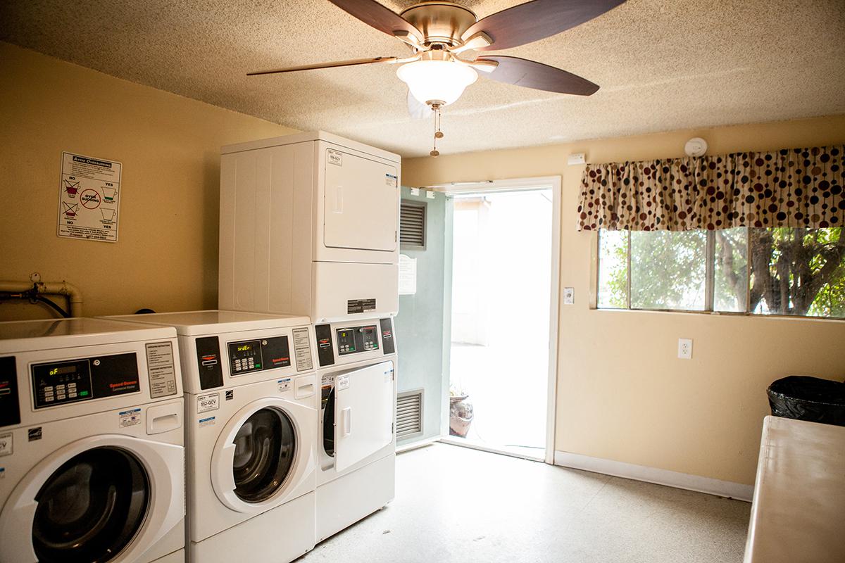 a kitchen with white cabinets and a microwave