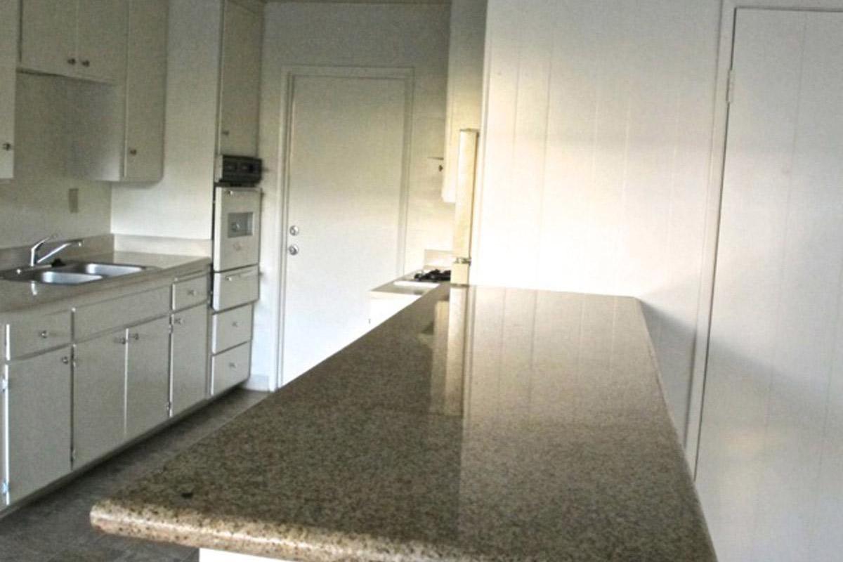 a large kitchen with stainless steel appliances