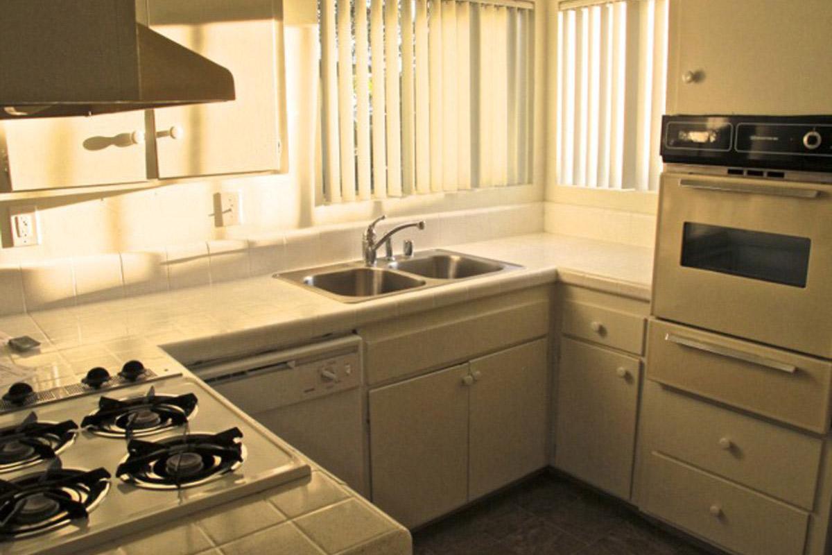 a stove top oven sitting inside of a kitchen