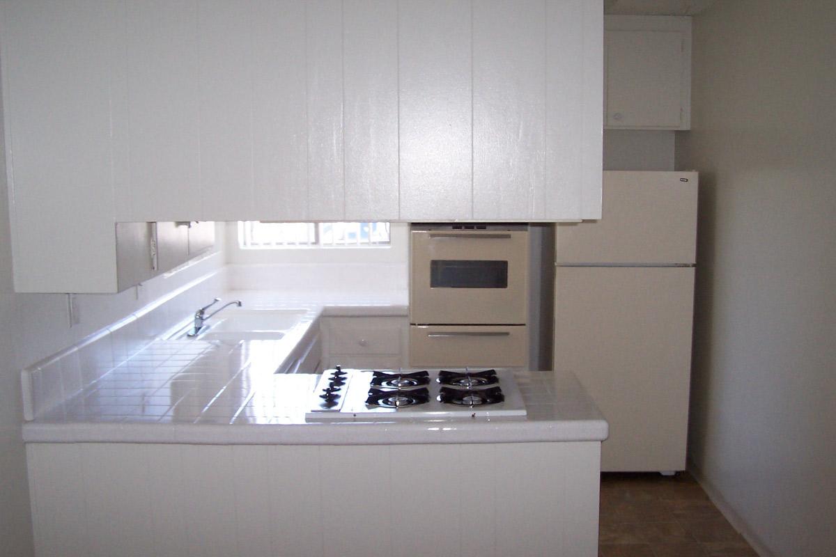 a white refrigerator freezer sitting inside of a kitchen