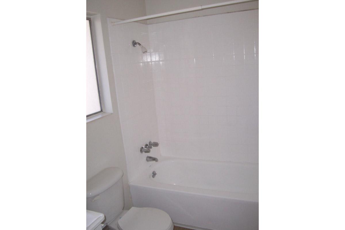 a white tub sitting next to a shower