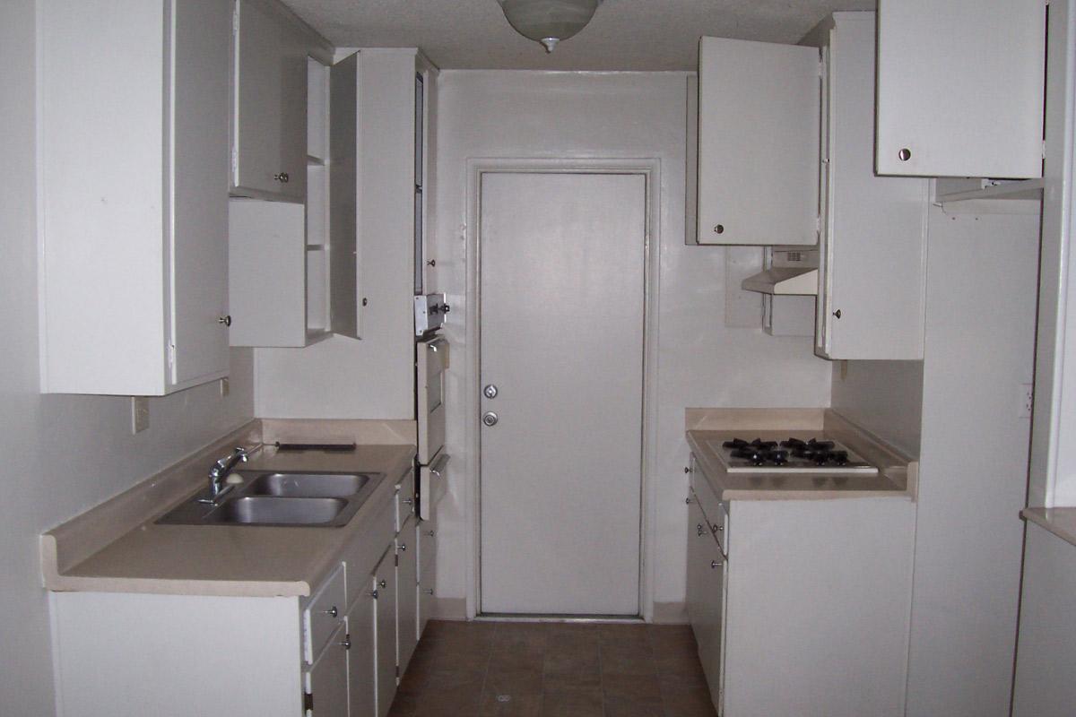 a kitchen with a sink and a mirror