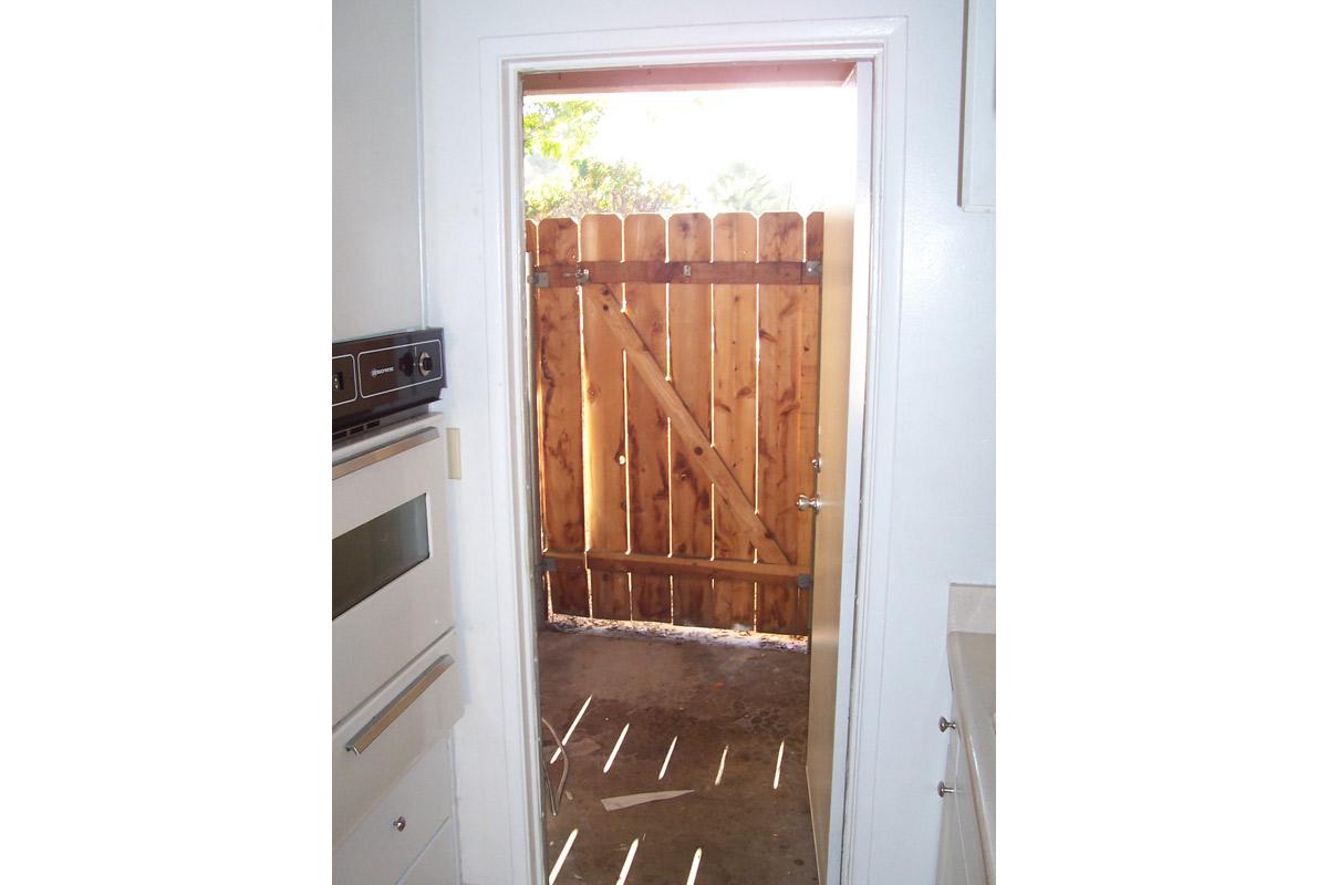 a cat sitting on top of a wooden door