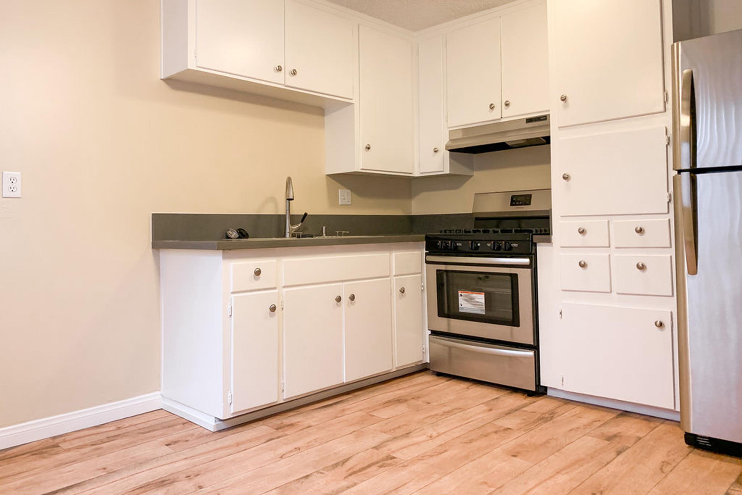 a kitchen with white appliances and wooden cabinets