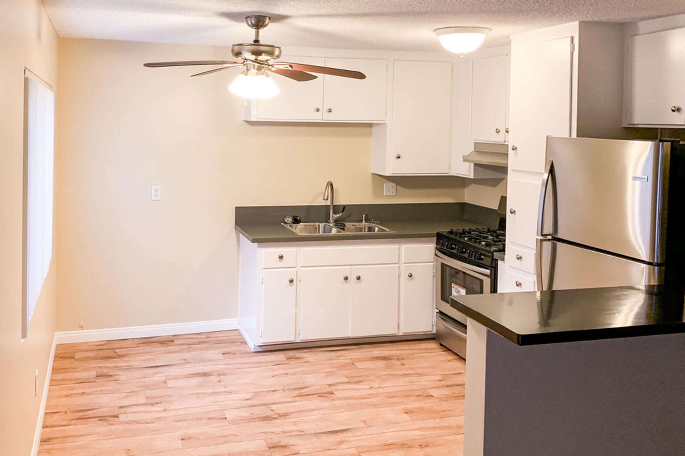 a kitchen with a stove and a refrigerator