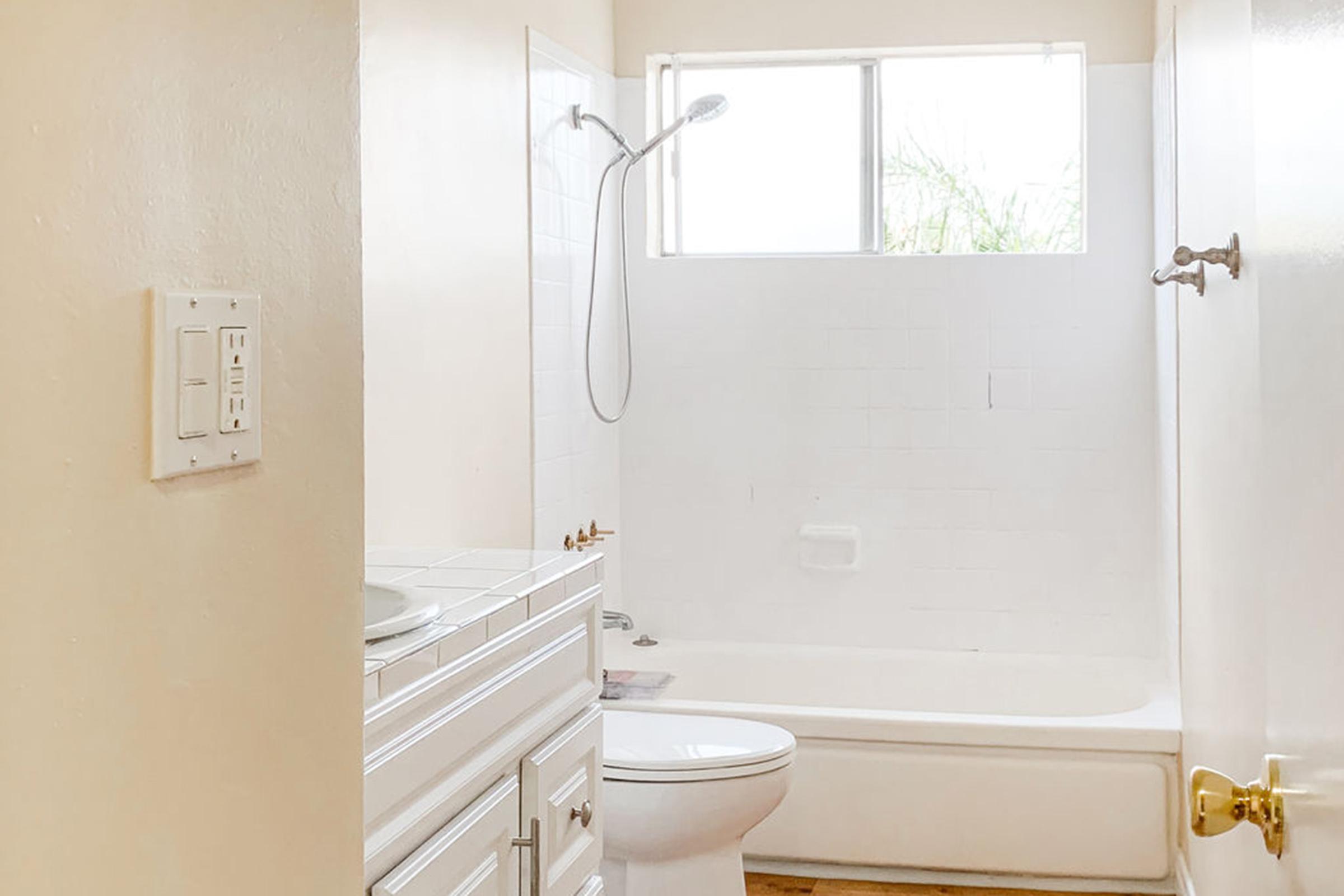 a white tub sitting next to a sink