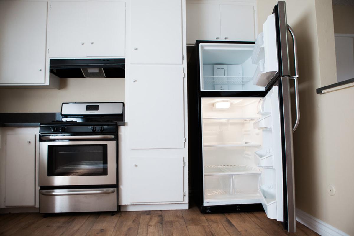 a kitchen with a stove top oven sitting inside of a refrigerator