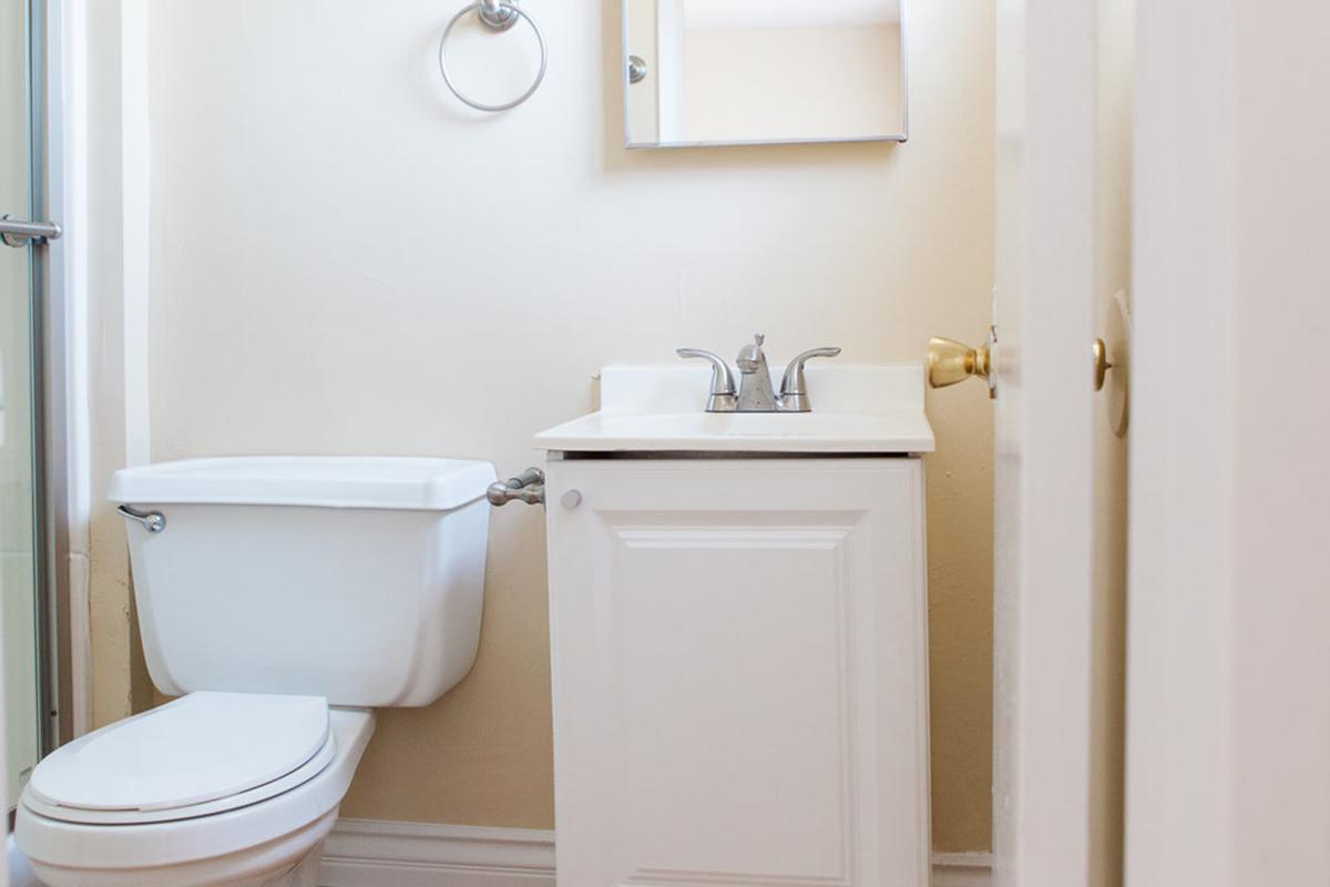 a white tub sitting next to a sink