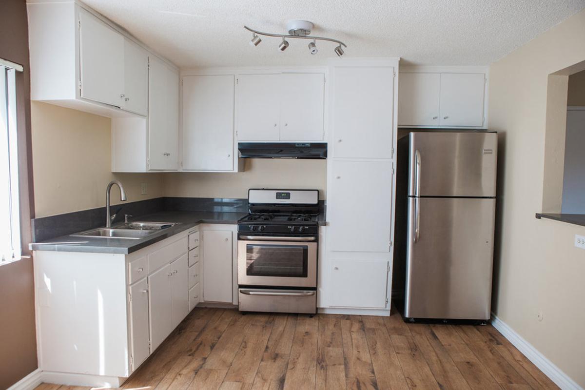 a kitchen with a stove and a refrigerator