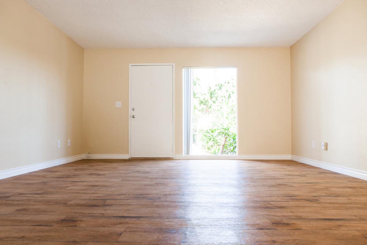 a large empty room with a hard wood floor