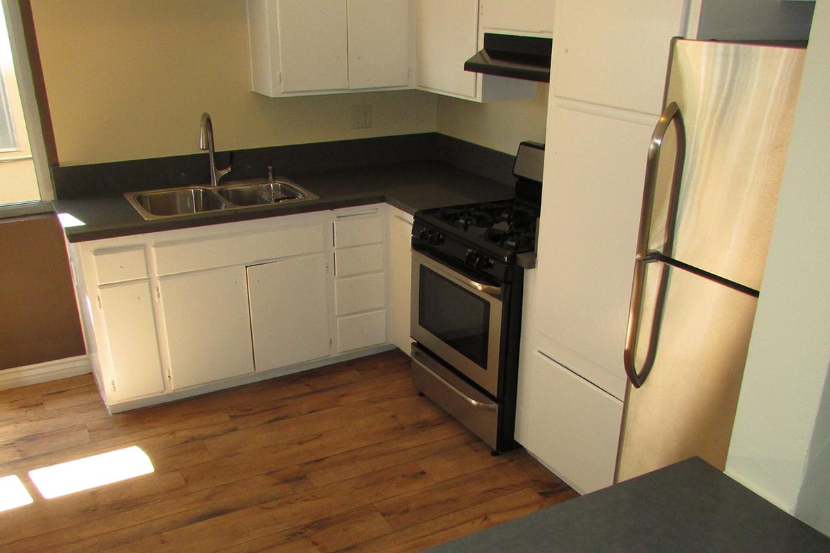 a kitchen with a stove top oven sitting inside of a refrigerator