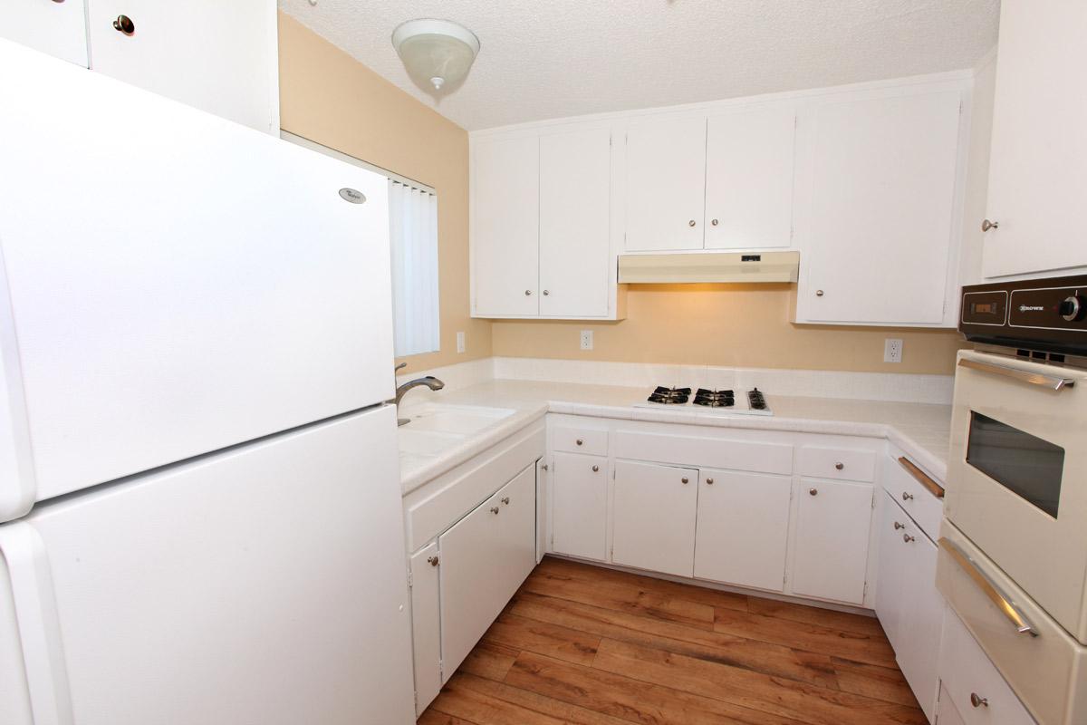 a white refrigerator freezer sitting inside of a kitchen