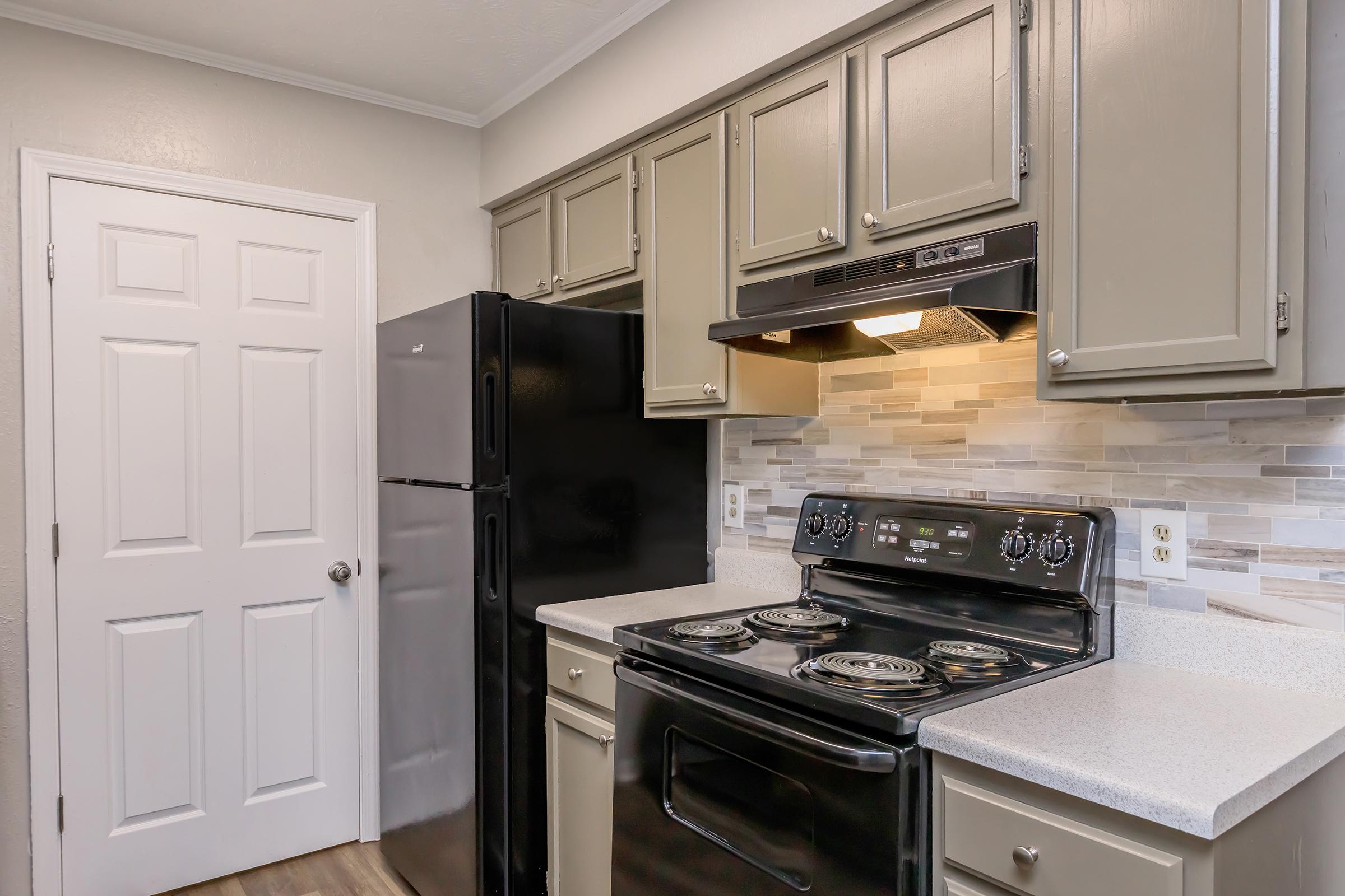 a stove top oven sitting inside of a kitchen