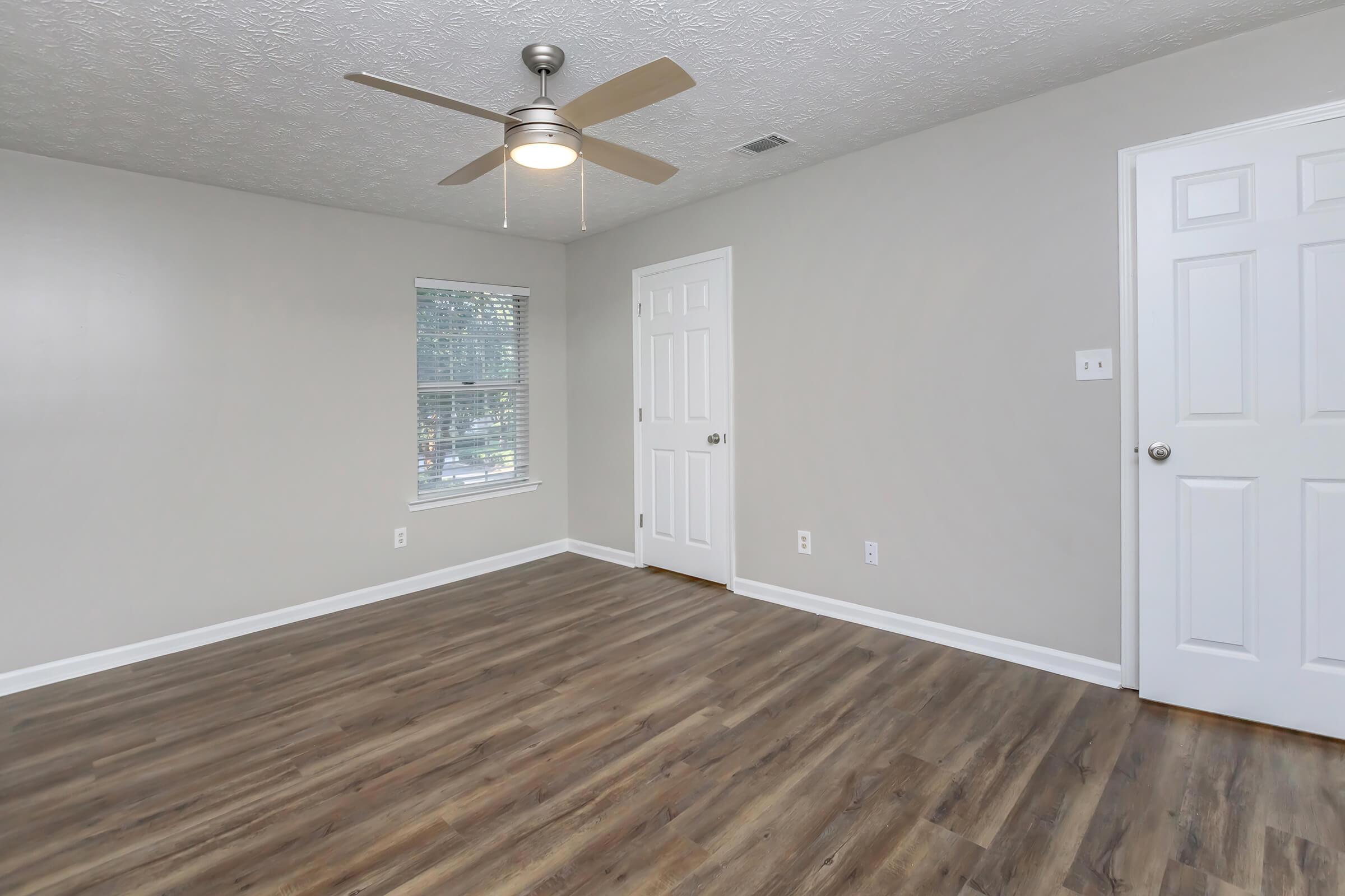 a large empty room with a wooden floor