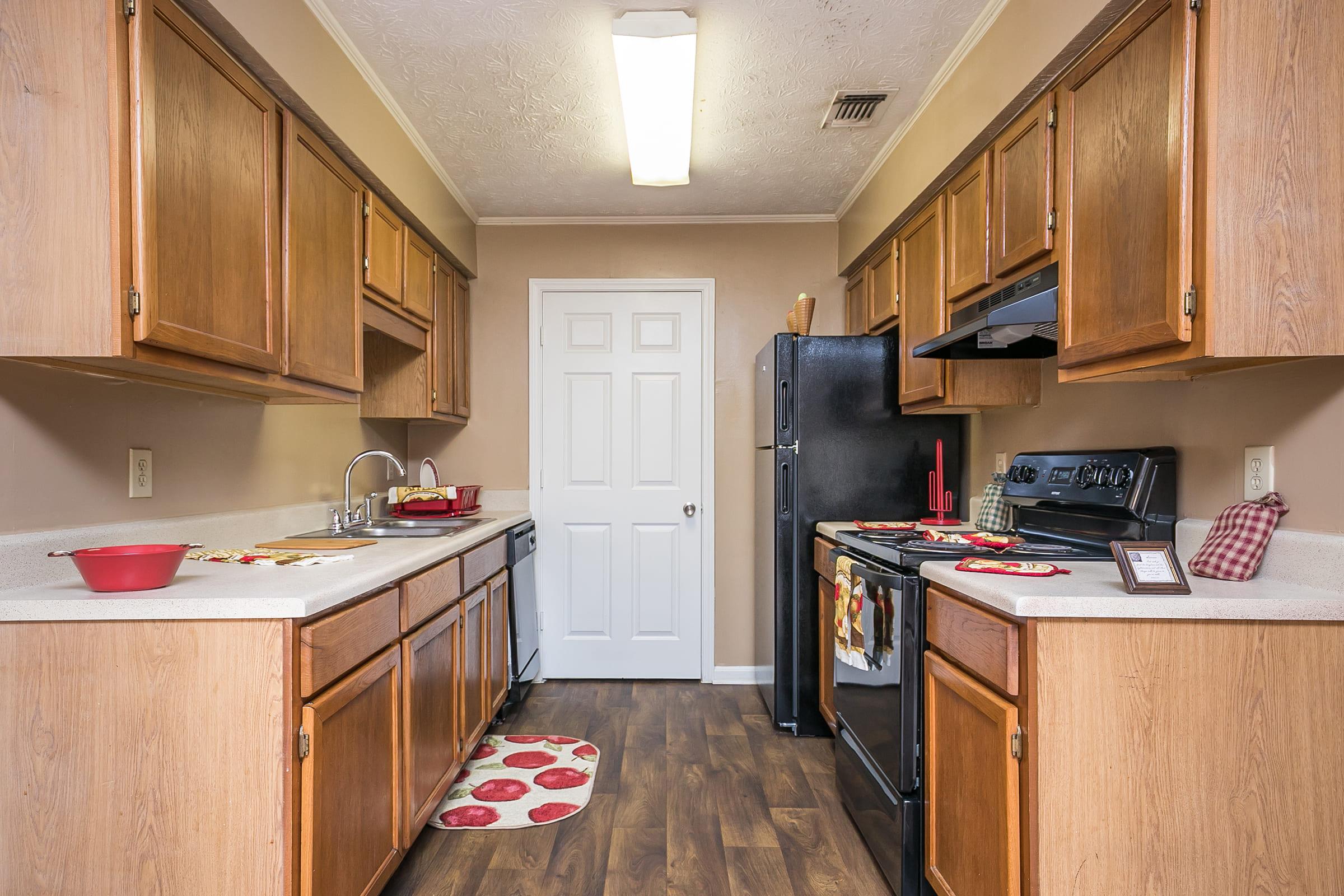 a kitchen with a stove sink and refrigerator