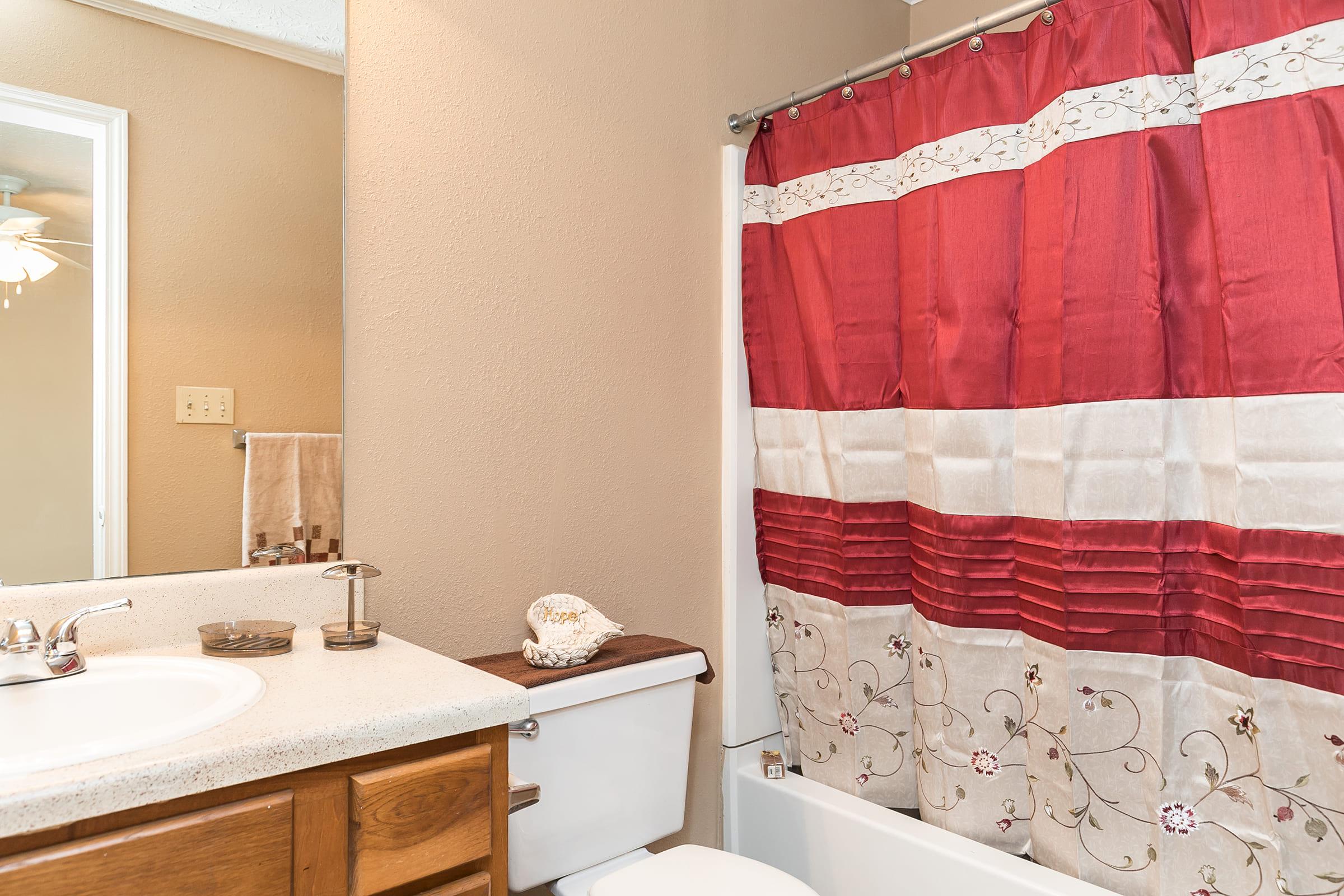 a bedroom area with a sink and a mirror