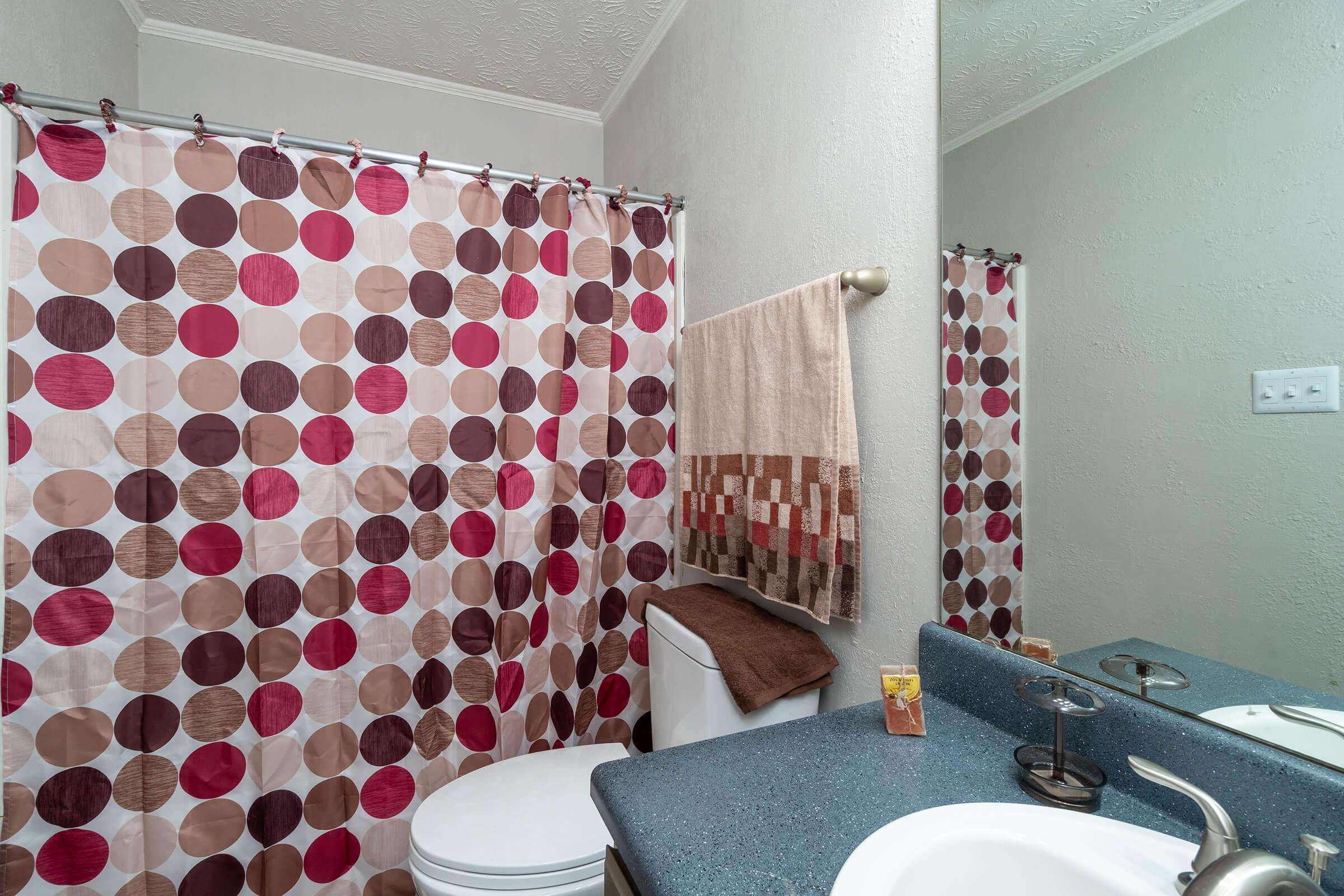 a shower curtain next to a sink