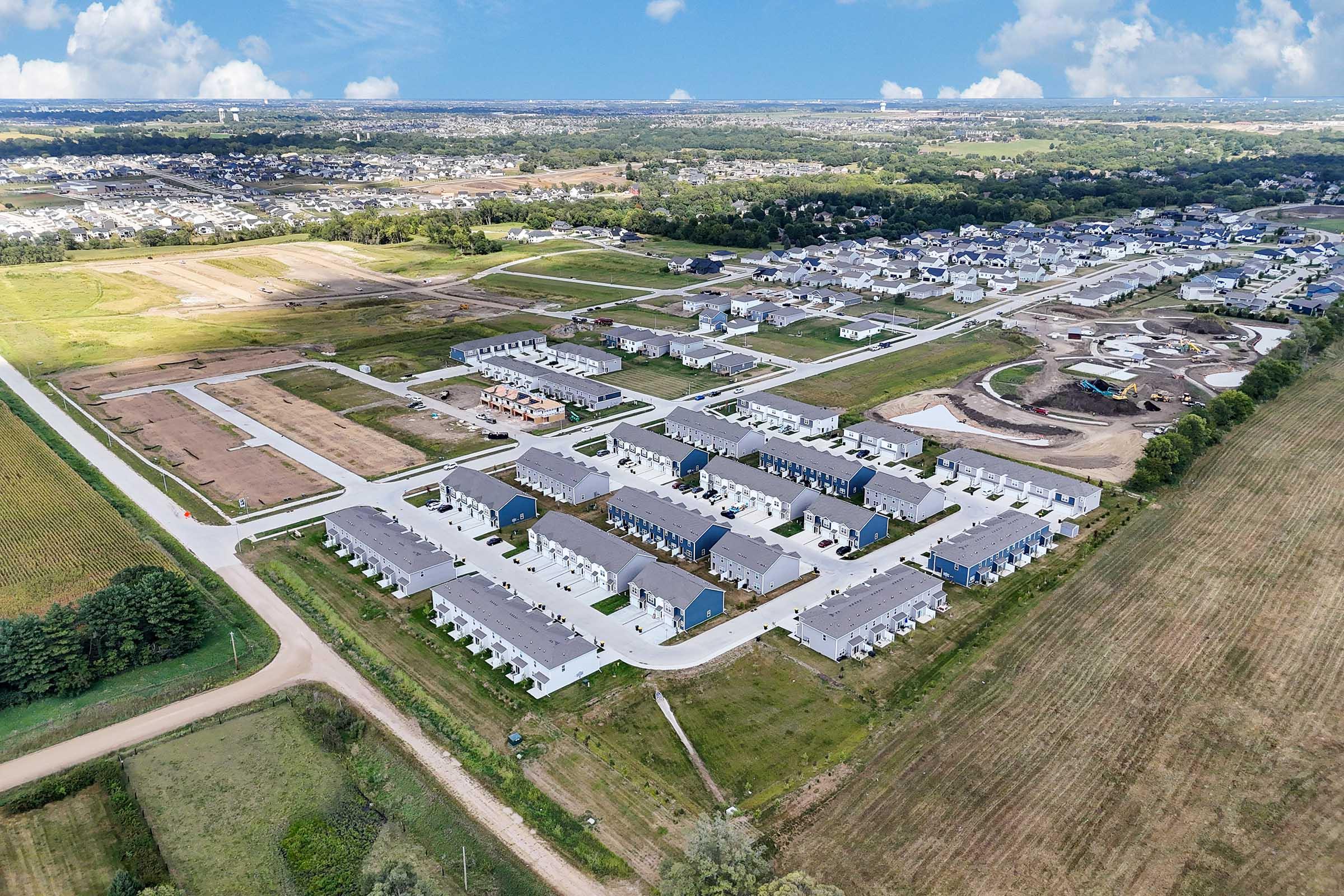 Wide aerial view of Painted Woods Villas brand-new townhome community in Waukee near West Des Moines.