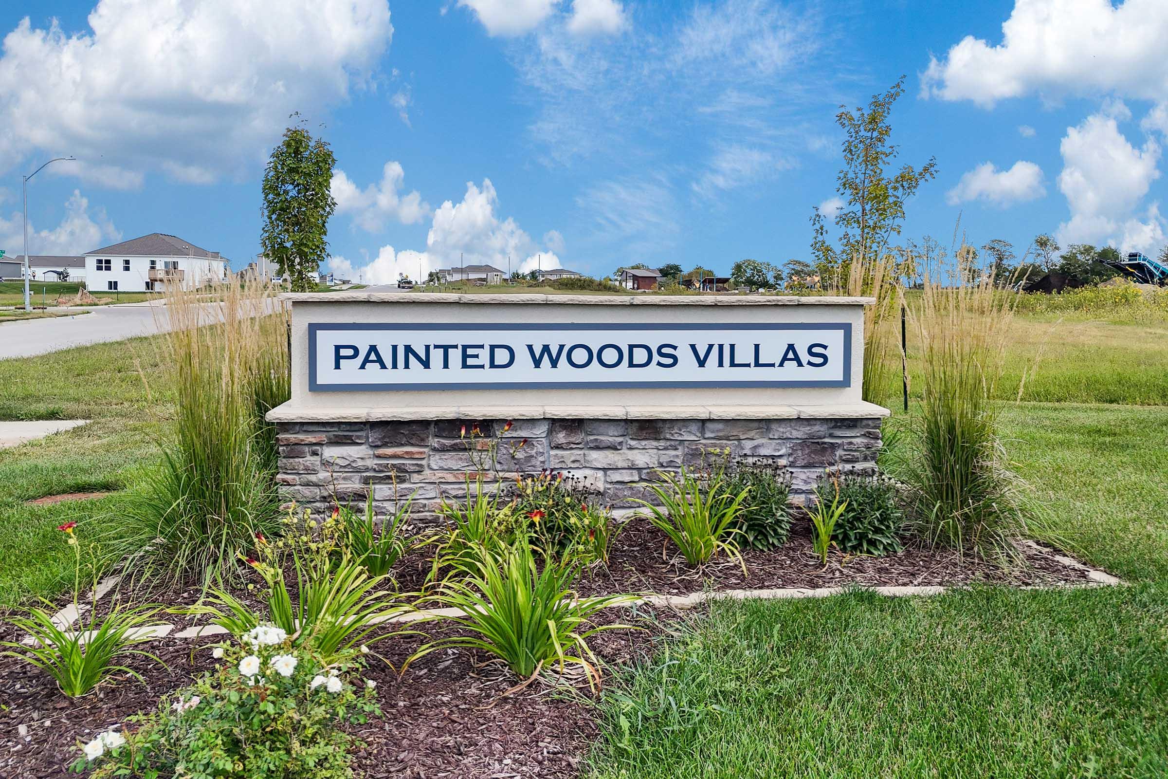 Painted Woods Villas monument sign welcoming residents to new construction townhomes in Waukee School District.