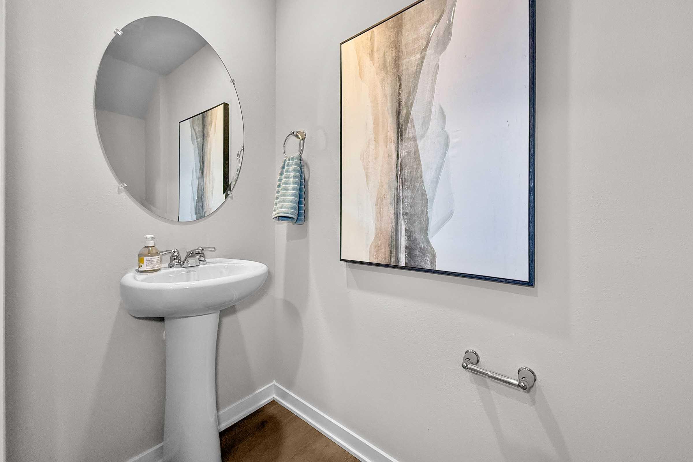 Half bathroom with pedestal sink in new Painted Woods Villas townhome in Waukee.