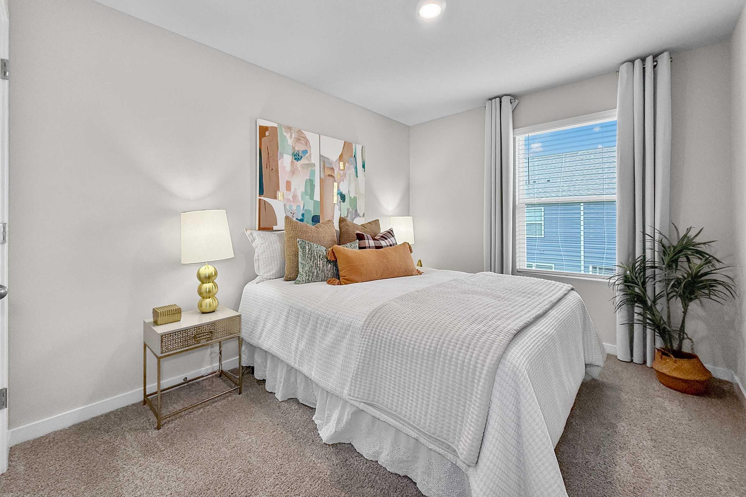 Spacious primary bedroom with natural light in three-bedroom townhome at Painted Woods Villas.