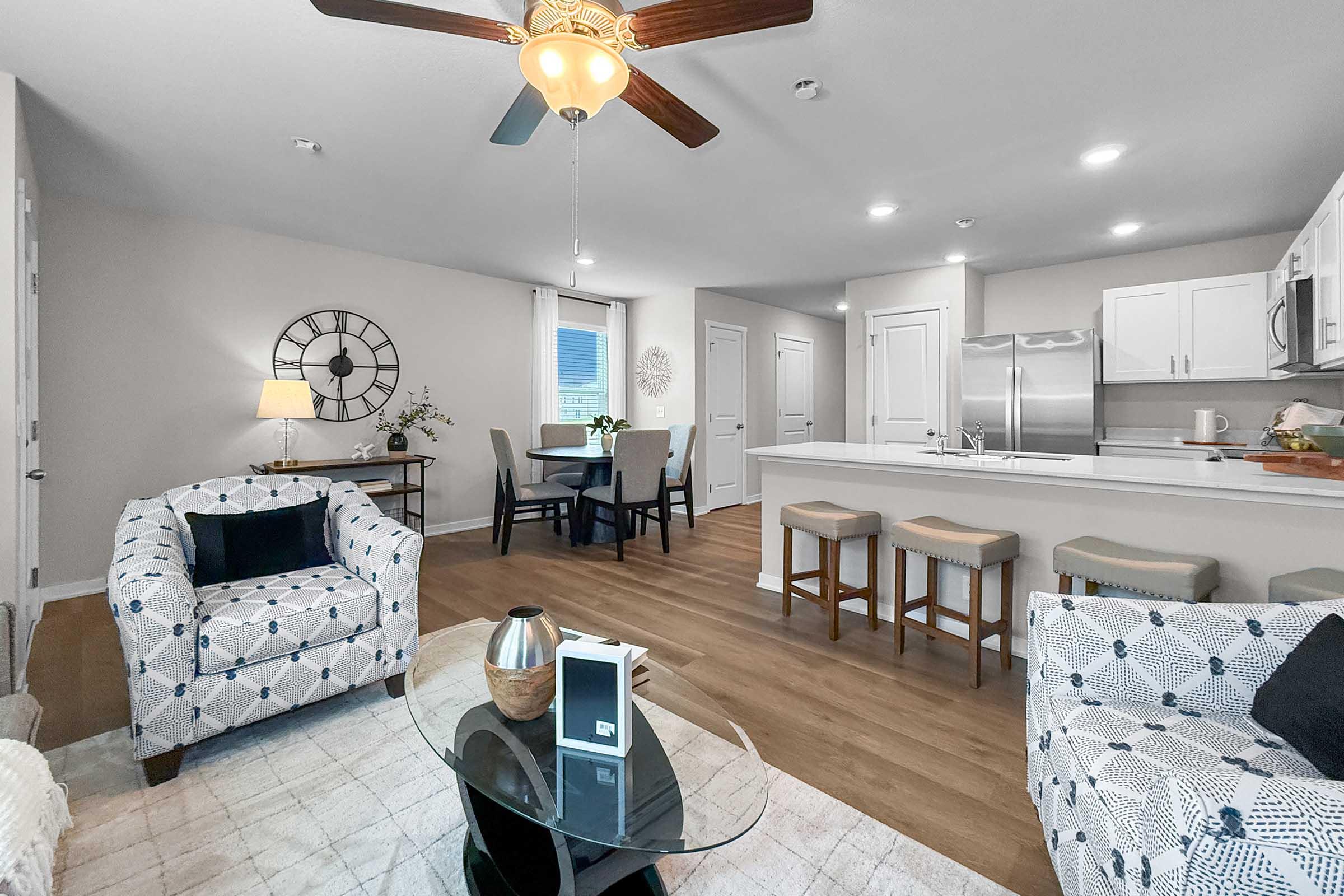 Spacious open-concept living area with dining space in Waukee townhome at Painted Woods Villas.