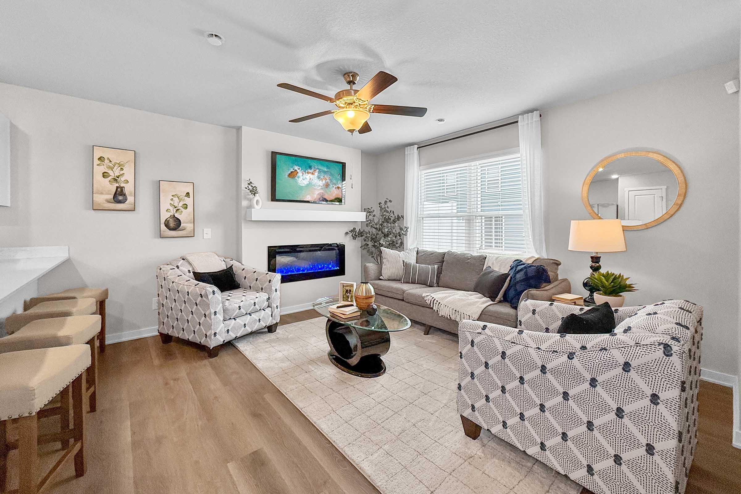 Stylish furnished living room in new construction Painted Woods Villas townhome in Waukee, IA.