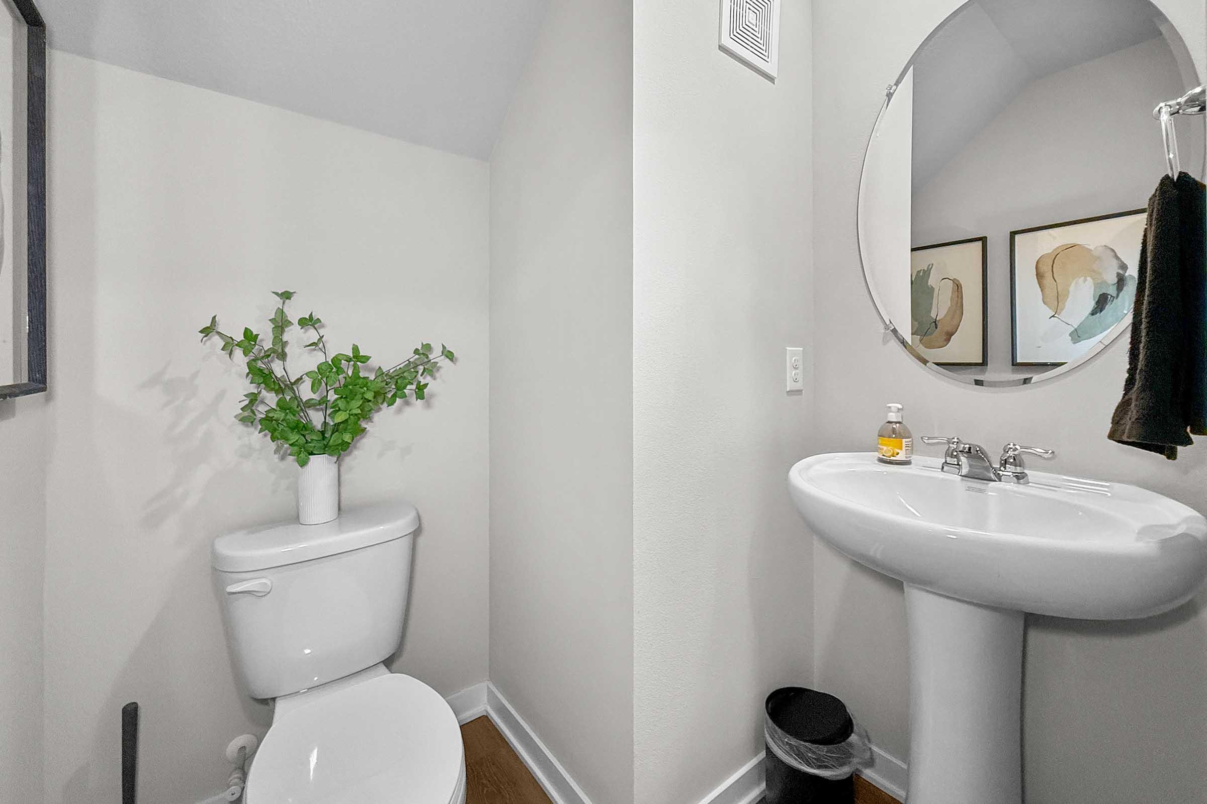 Half bathroom with pedestal sink in new construction townhome at Painted Woods Villas, Waukee, IA.
