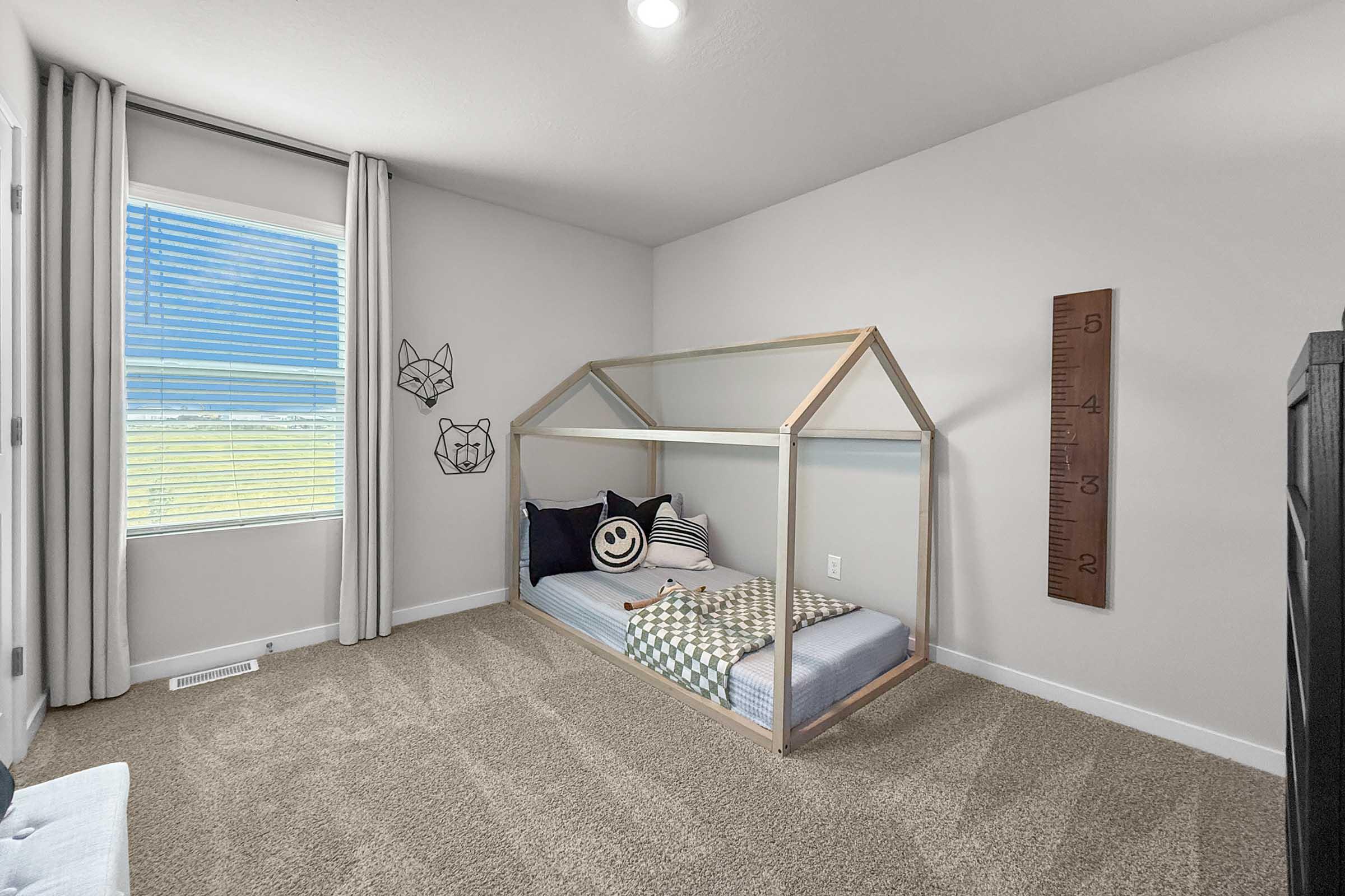 Secondary bedroom staged with kids’ furniture in three-bedroom Painted Woods Villas townhome.