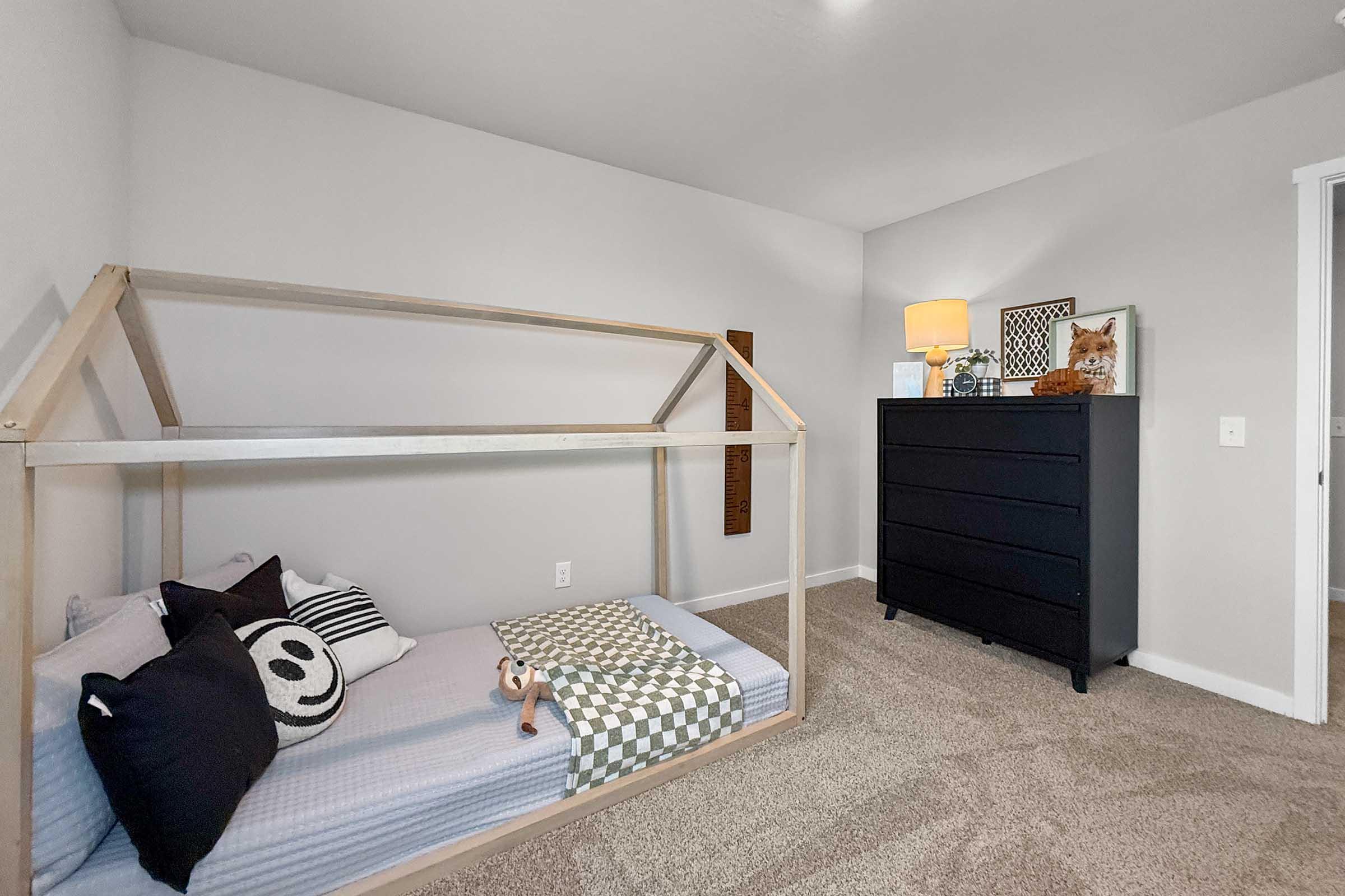 Bright bedroom with neutral décor and carpet flooring in Painted Woods Villas townhome in Waukee.