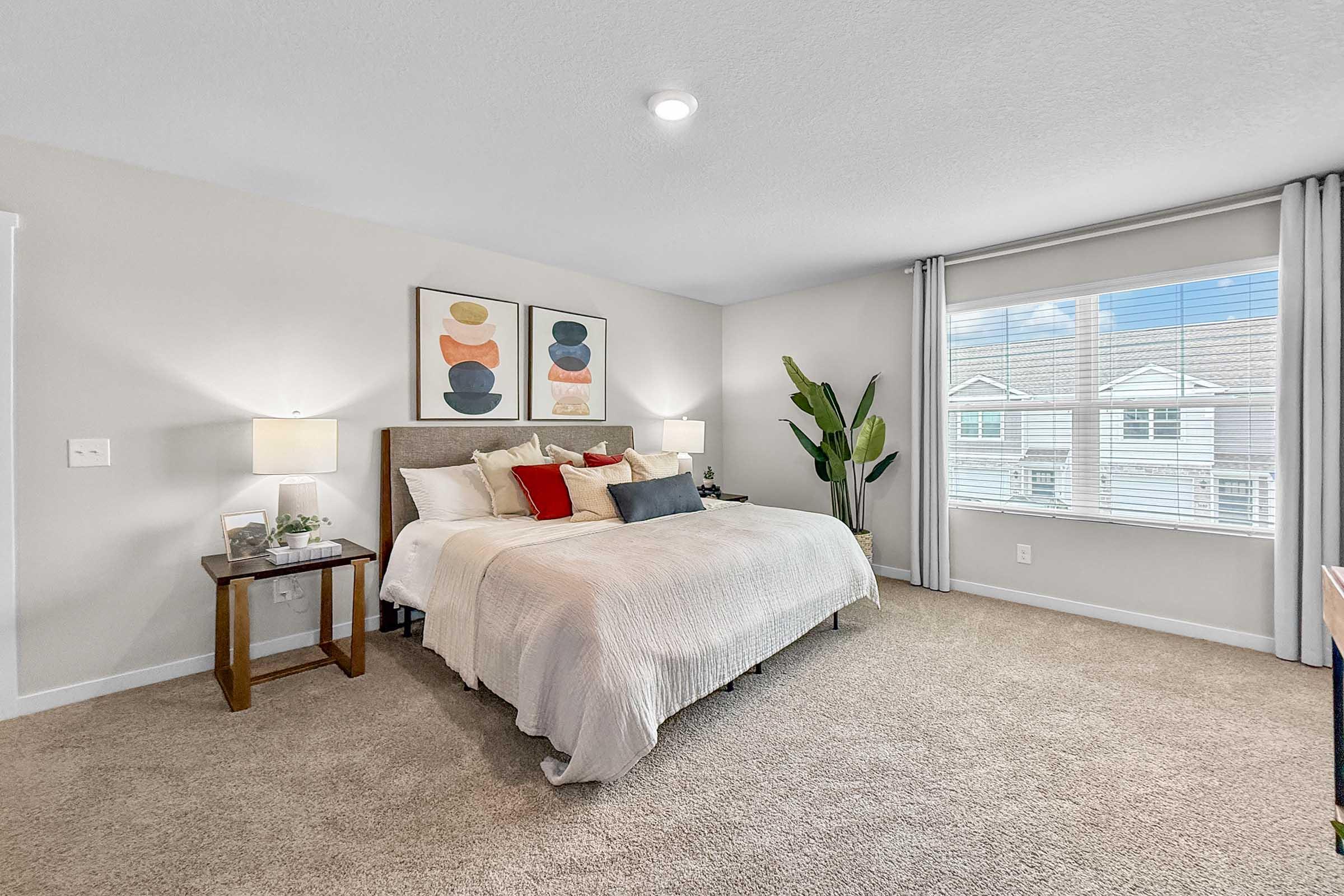 Large bedroom with natural light and modern finishes at Painted Woods Villas in Waukee.