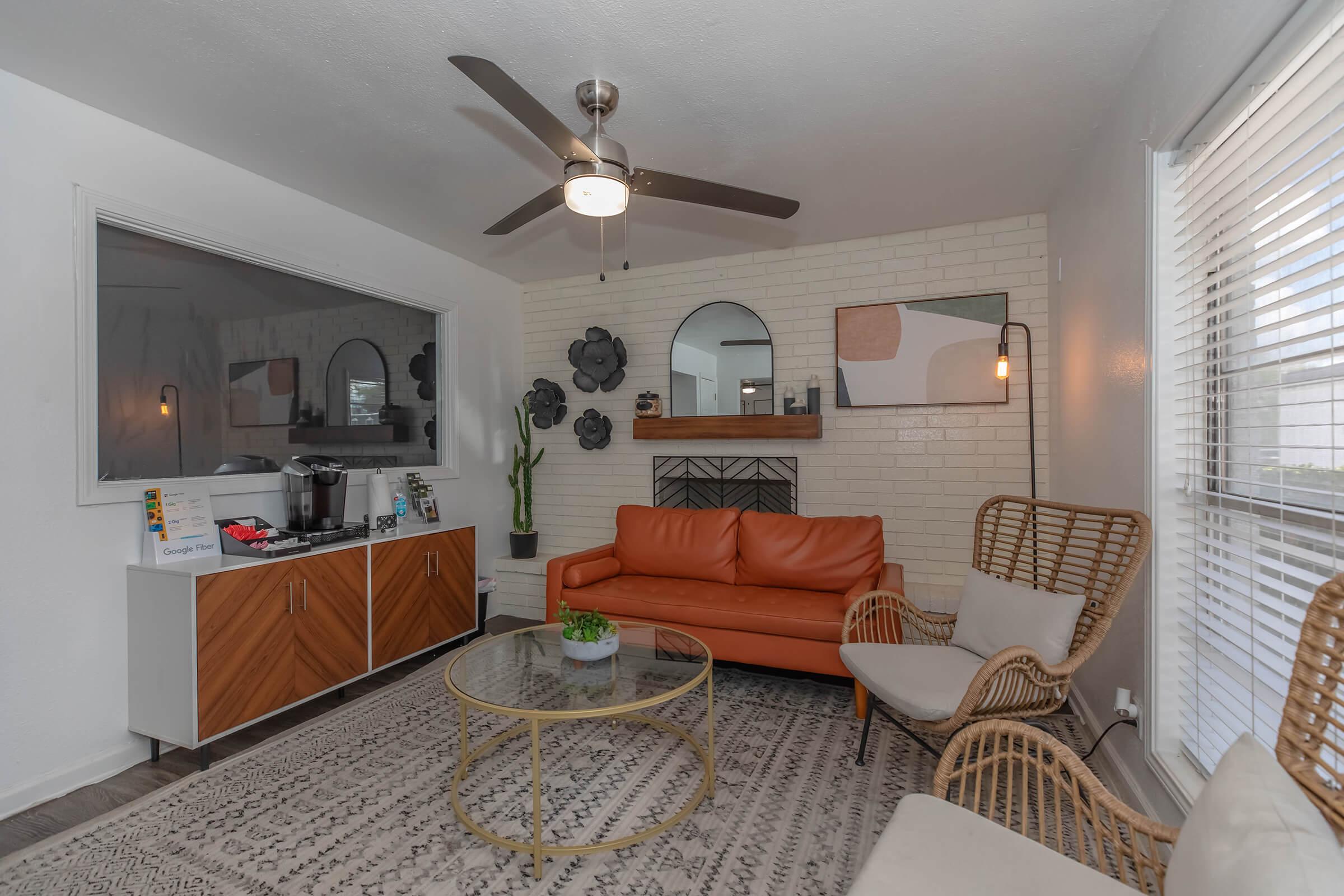 a living room filled with furniture and a large window