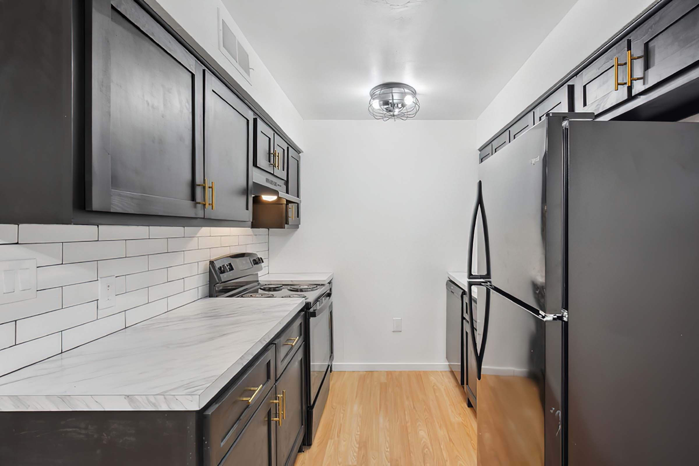 a kitchen with stainless steel appliances and wooden cabinets