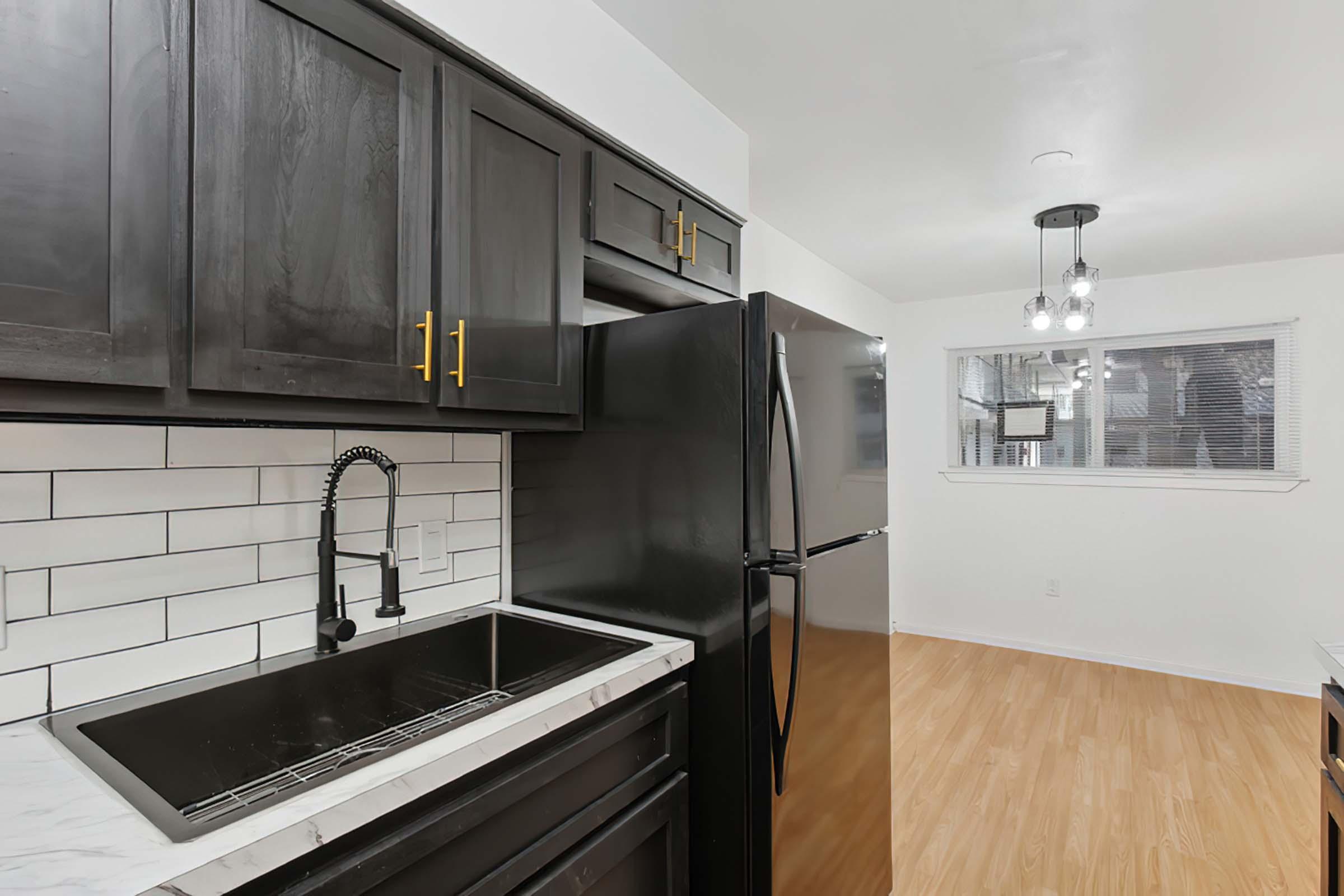 a kitchen with stainless steel appliances and wooden cabinets