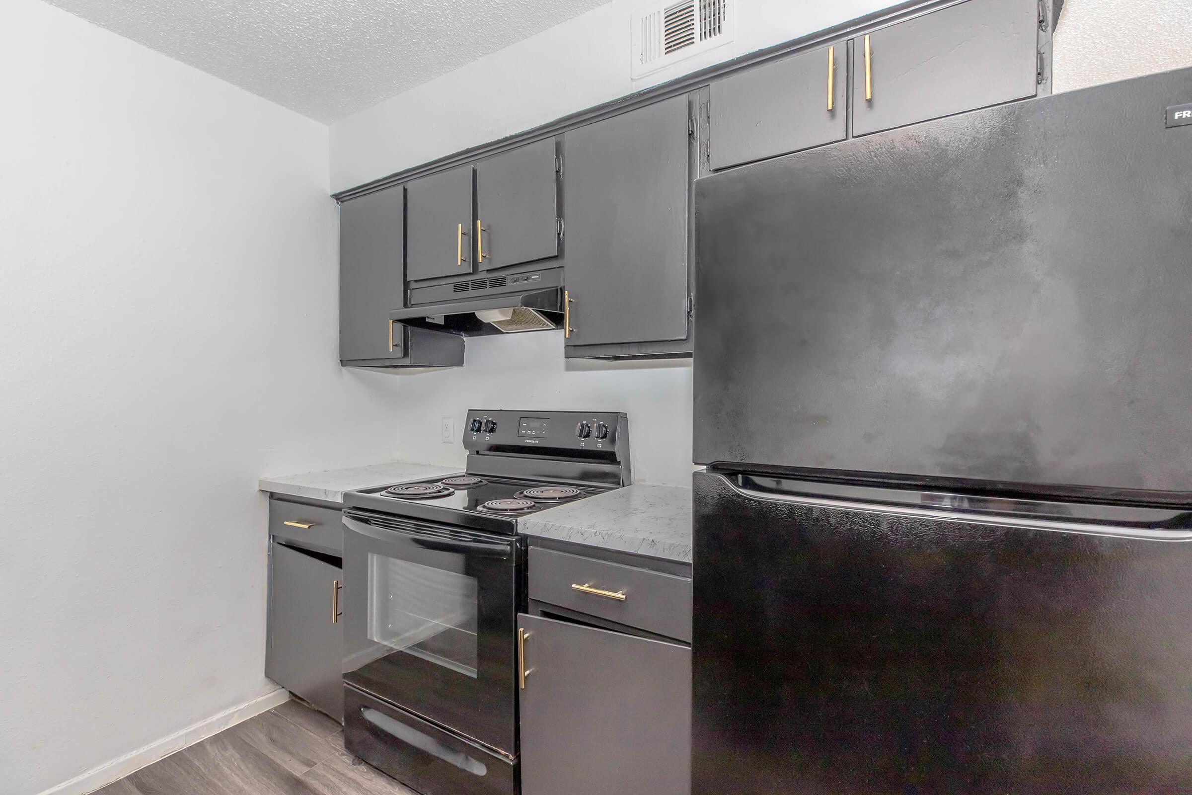 a stove top oven sitting inside of a kitchen