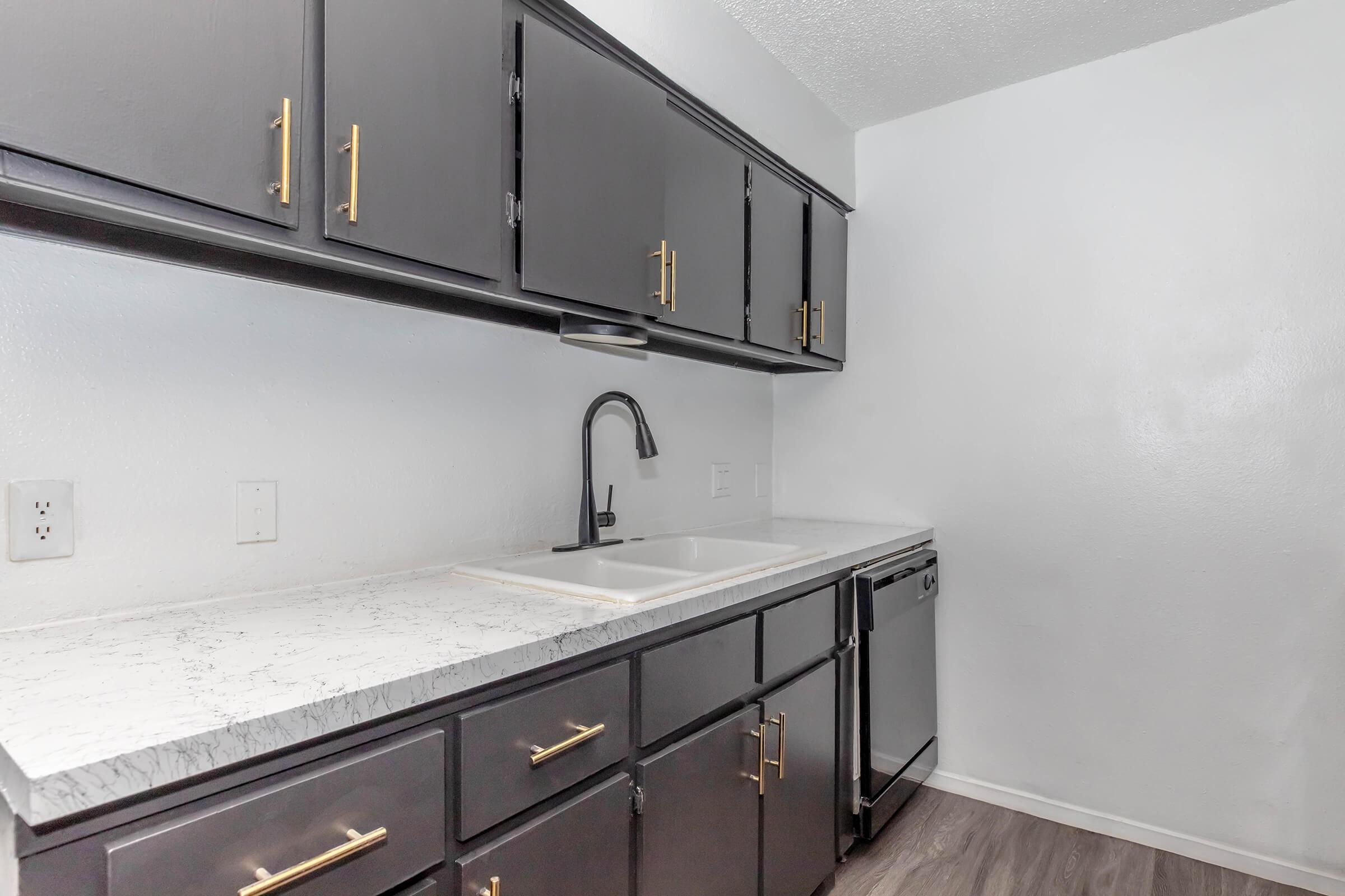 a kitchen with a sink and a mirror