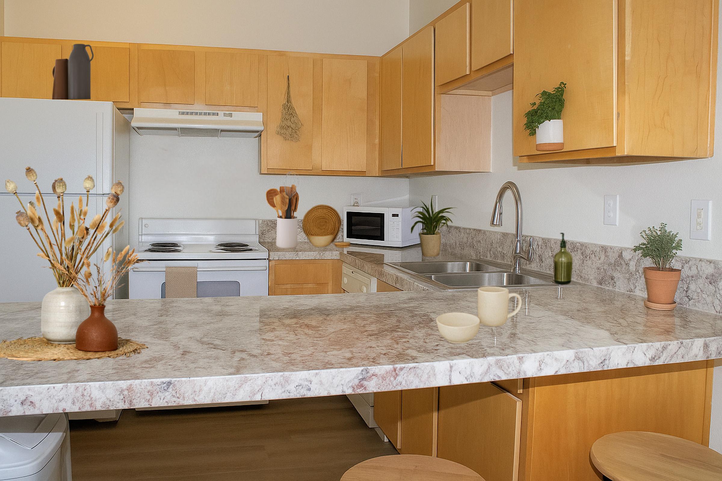 A modern kitchen with light wood cabinets and a marble countertop. Features include a white stove, microwave, and a sink with a faucet. Decorative elements include a vase with dried flowers, a plant on the counter, and two stools. Soft lighting creates a warm, inviting atmosphere.