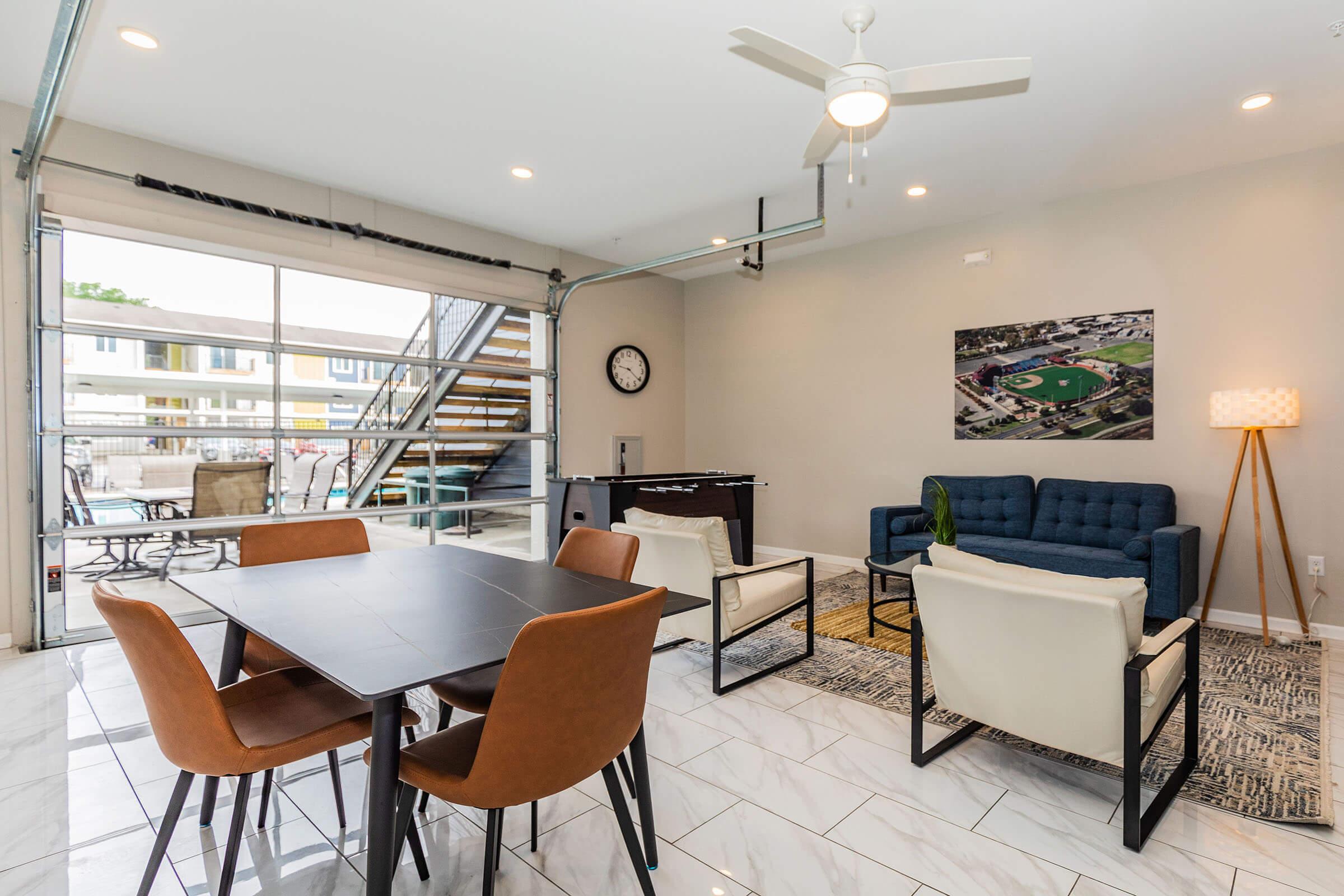 a living area with a desk and chair in a room