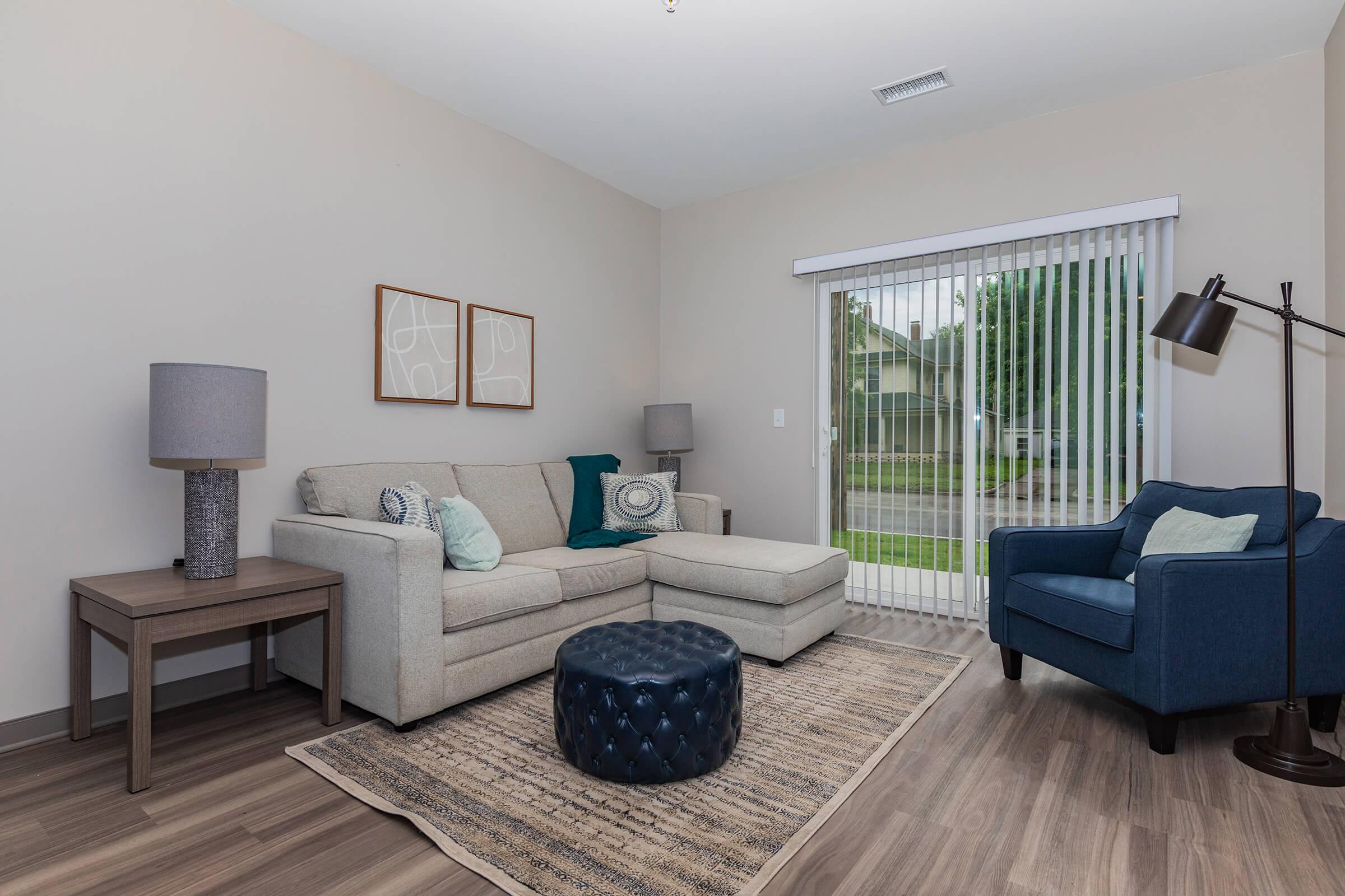 a living room filled with furniture and a flat screen tv