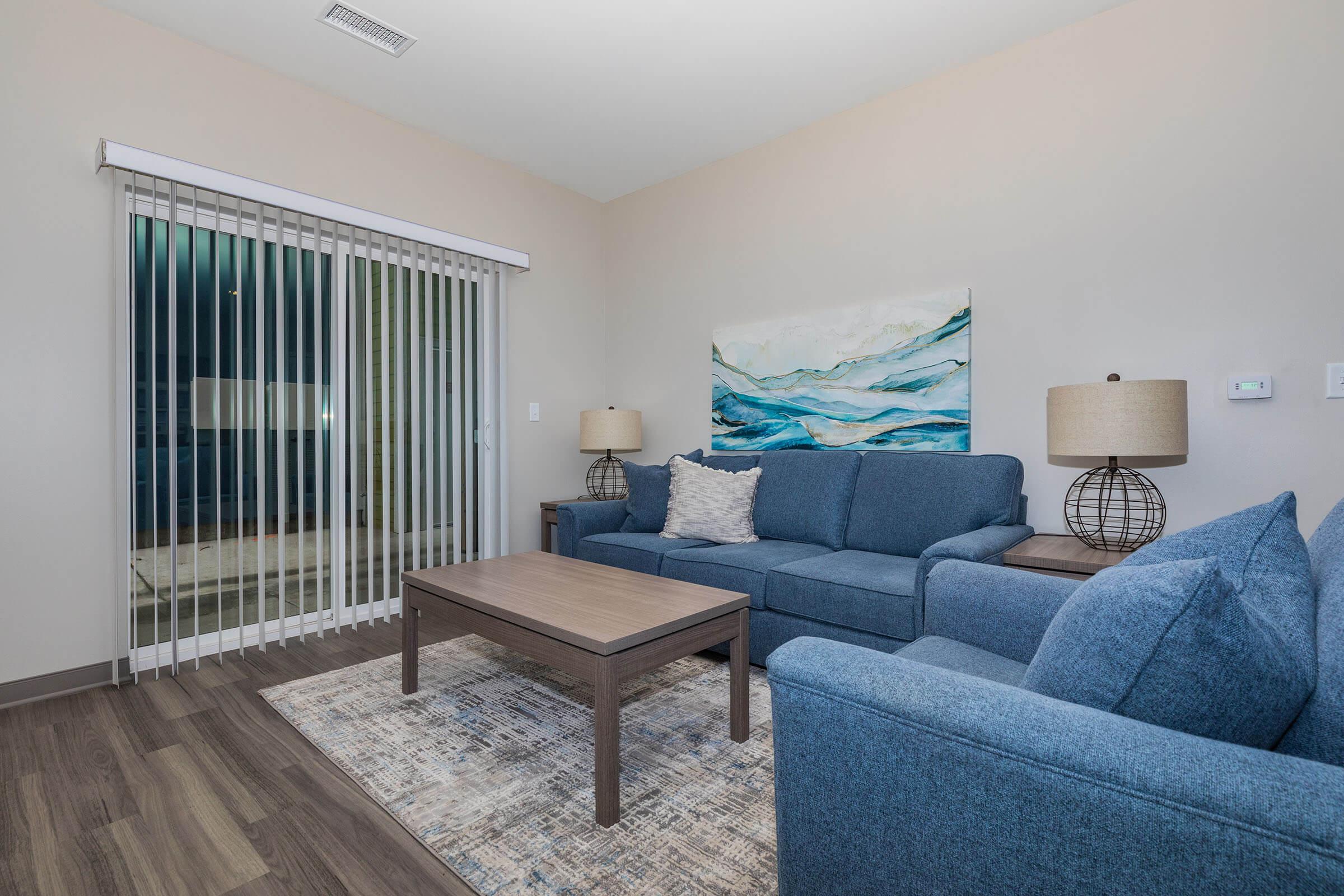 a living room filled with furniture and a large window