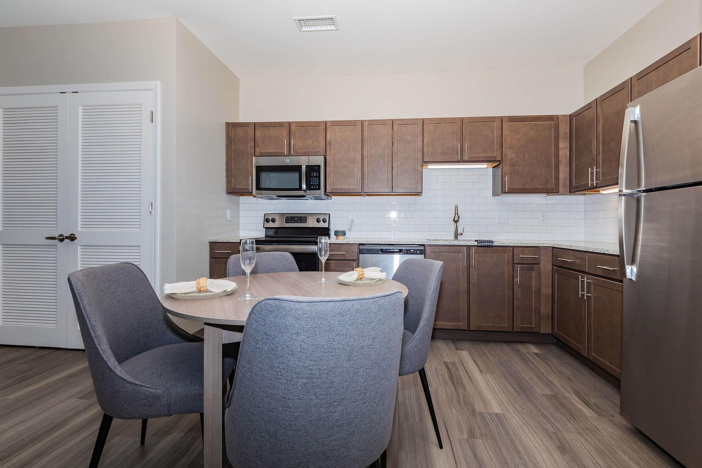 a kitchen with a sink and a chair in a room