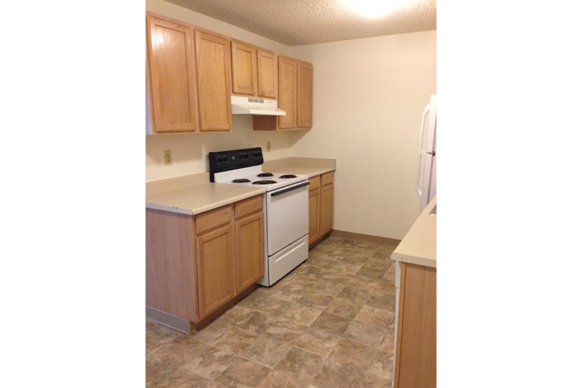 a kitchen with stainless steel appliances and wooden cabinets