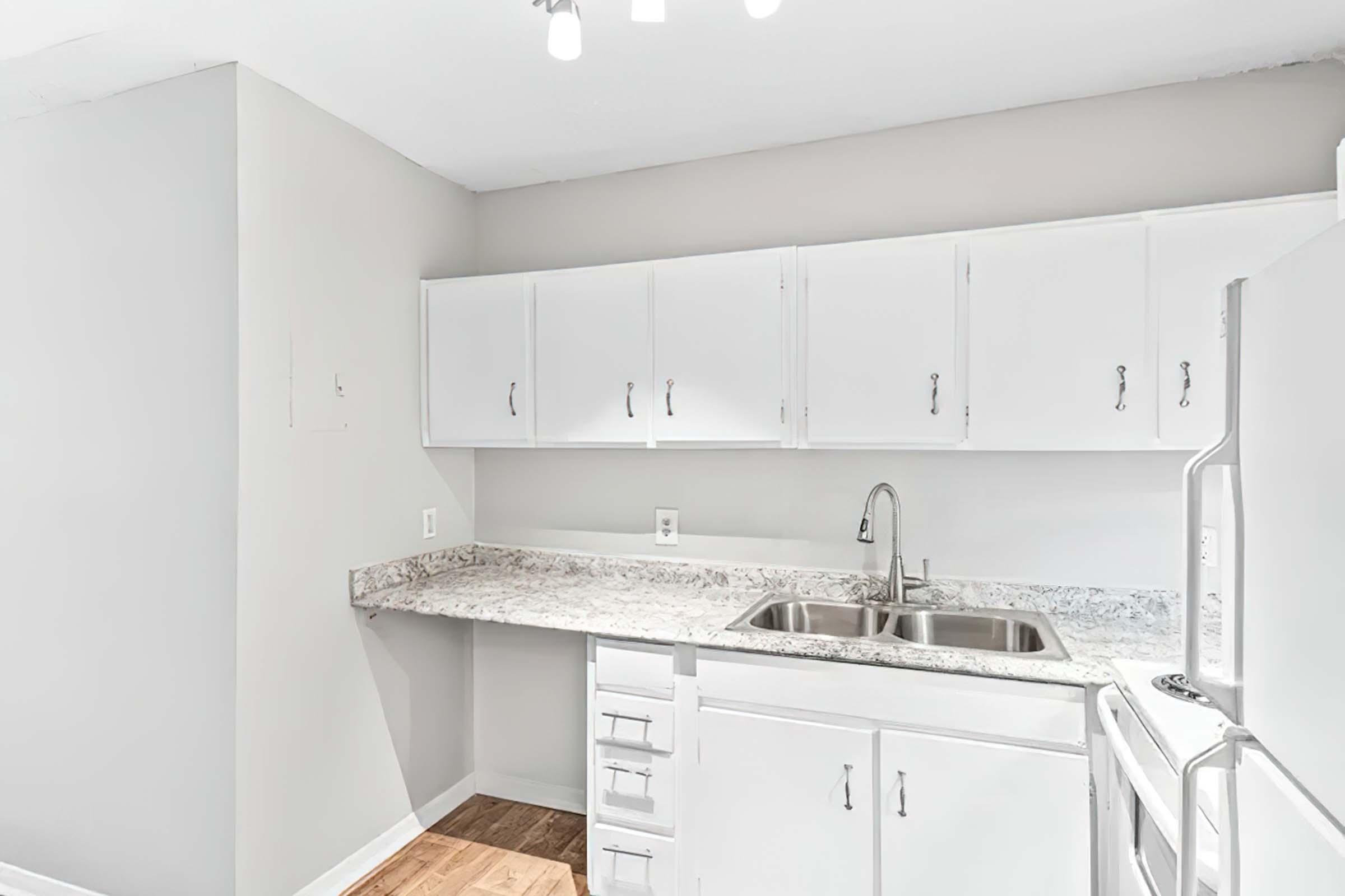 a kitchen with a stove sink and refrigerator