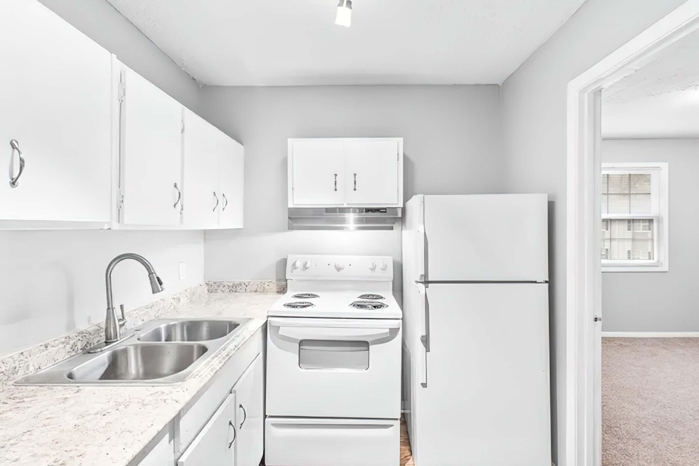 a kitchen with a stove sink and refrigerator