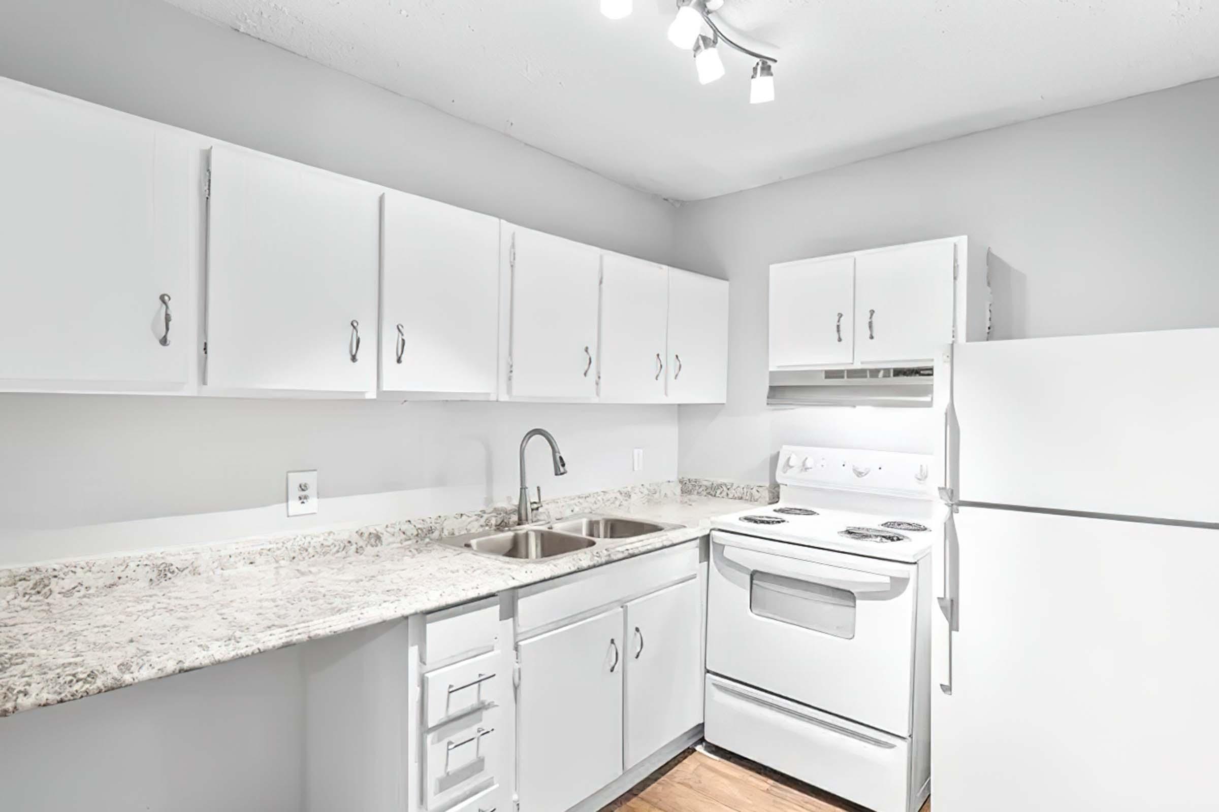 a kitchen with a stove sink and refrigerator