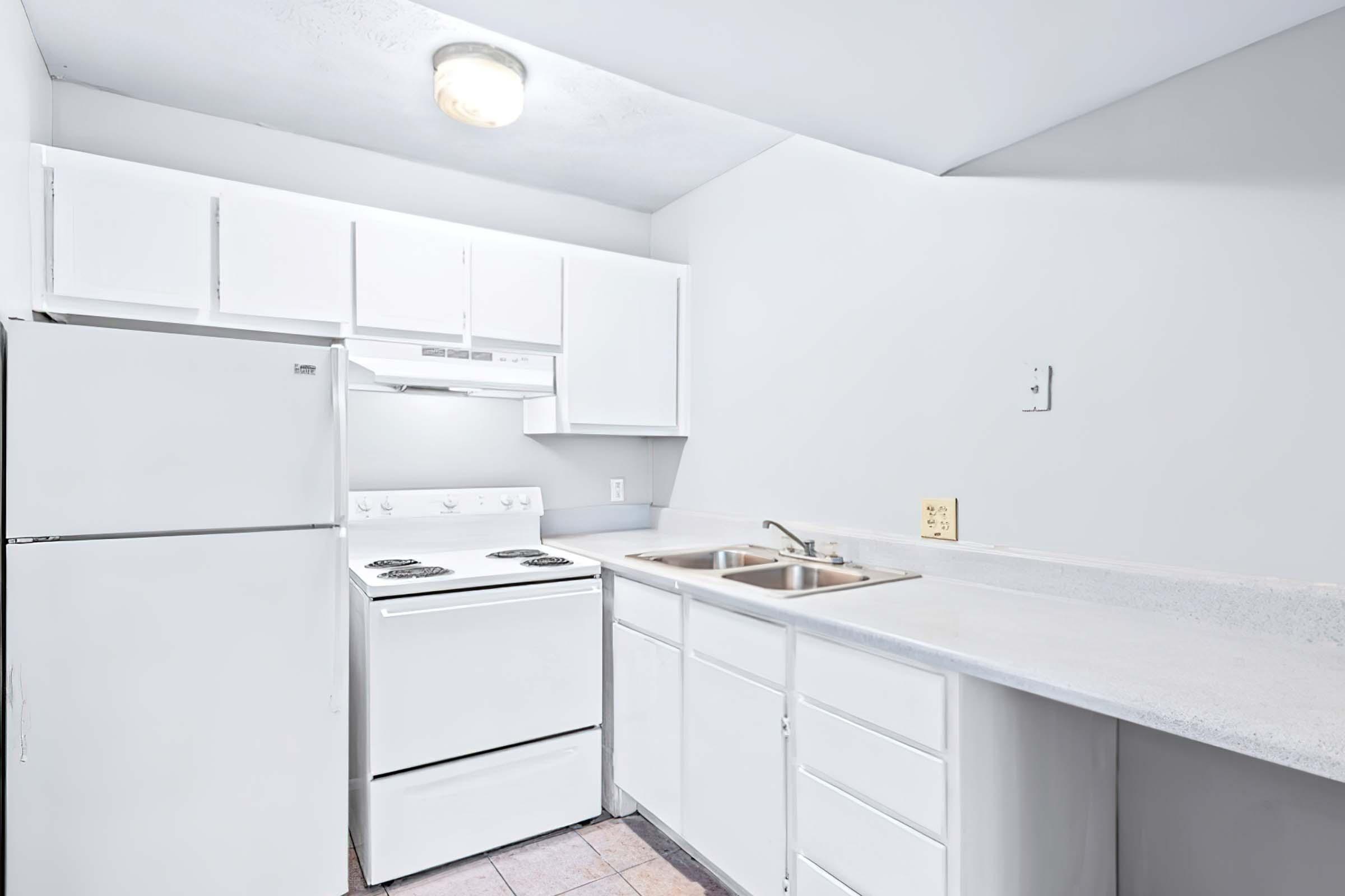 a kitchen with a sink and a refrigerator